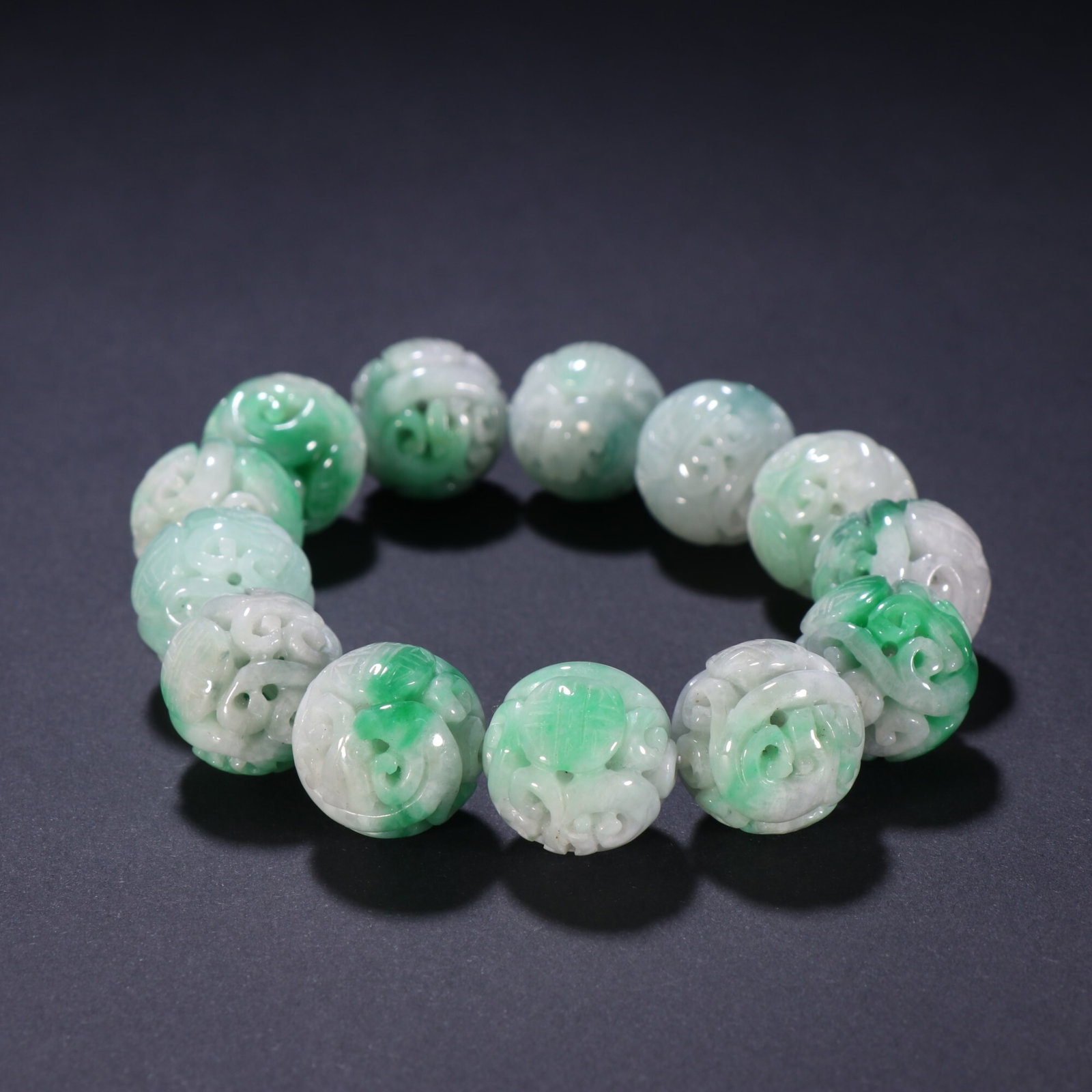 An Exquisite Jadeite Hollow Bracelet With Chilong Holding Longevity Motif: An Exquisite Jadeite Hollow Bracelet With Chilong Holding Longevity Motif,China Qing Dynasty,Dimension:(Bead Diameter)0.7in,Weight:87g,翡翠镂雕螭龙捧寿&