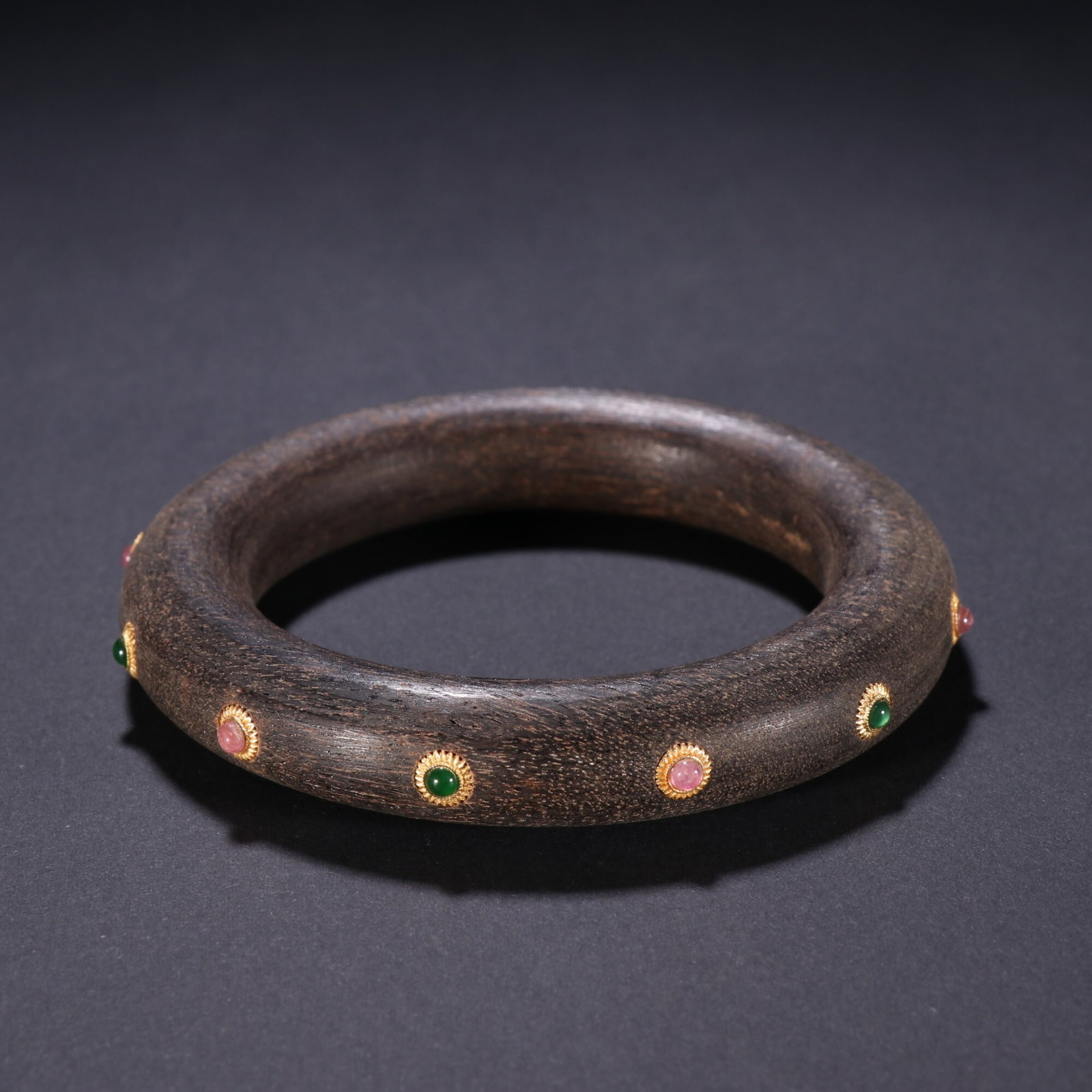 An Exquisite Agarwood Bangle Inlaid With Jadeite And Tourmaline (1 of 9)