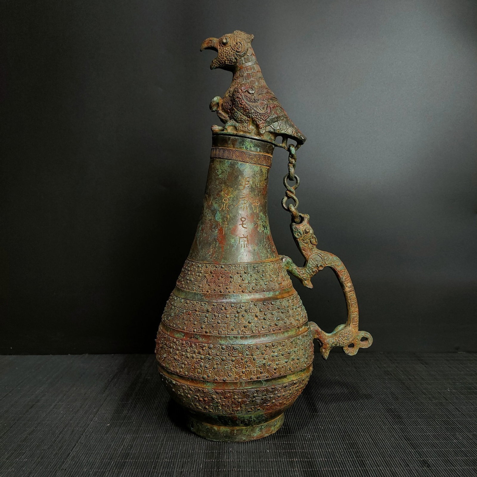 A Fine Bronze Chain?Handle Pot With Bird Cover And Pan?Chilong Dragon Decoration: A Fine Bronze Chain‑Handle Pot With Bird Cover And Pan‑Chilong Dragon Decoration,Chinese Warring States Period,Dimensions:15inx7.9in,Weight:2700g,青铜鸟盖蟠&#