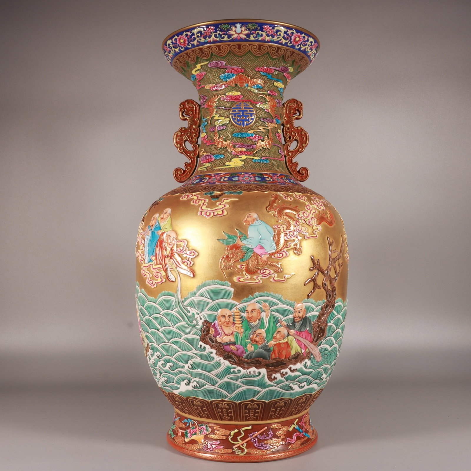 A Fine Enamel Color Carved Gilded Ground Double-Eared Vase with Eighteen Arhats: A Fine Enamel Color Carved Gilded Ground Double-Eared Vase with Eighteen Arhats,Qing Dynasty,China,Qianlong Six-character Mark,Size:18.8inx10.6in,珐琅彩雕刻金ࢸ