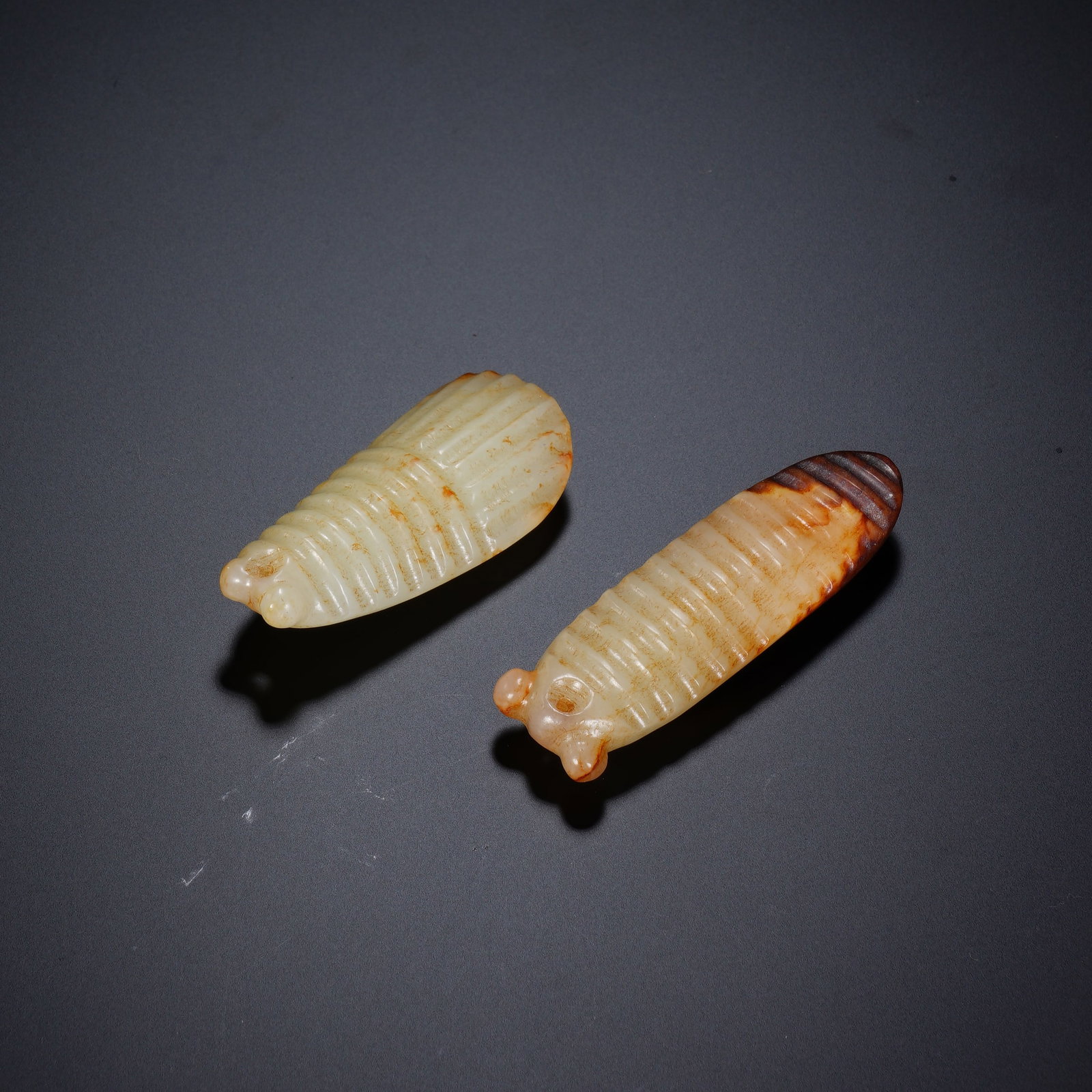 A Pair Of Exquisite White Jade Cicada Pendants With Ancient Patina: A Pair Of Exquisite White Jade Cicada Pendants With Ancient Patina,Han Dynasty,China. Dimensions:0.7inx2.3inx0.4in,0.9inx1.9inx0.5in. Weight:37g,一对白玉留沁蝉