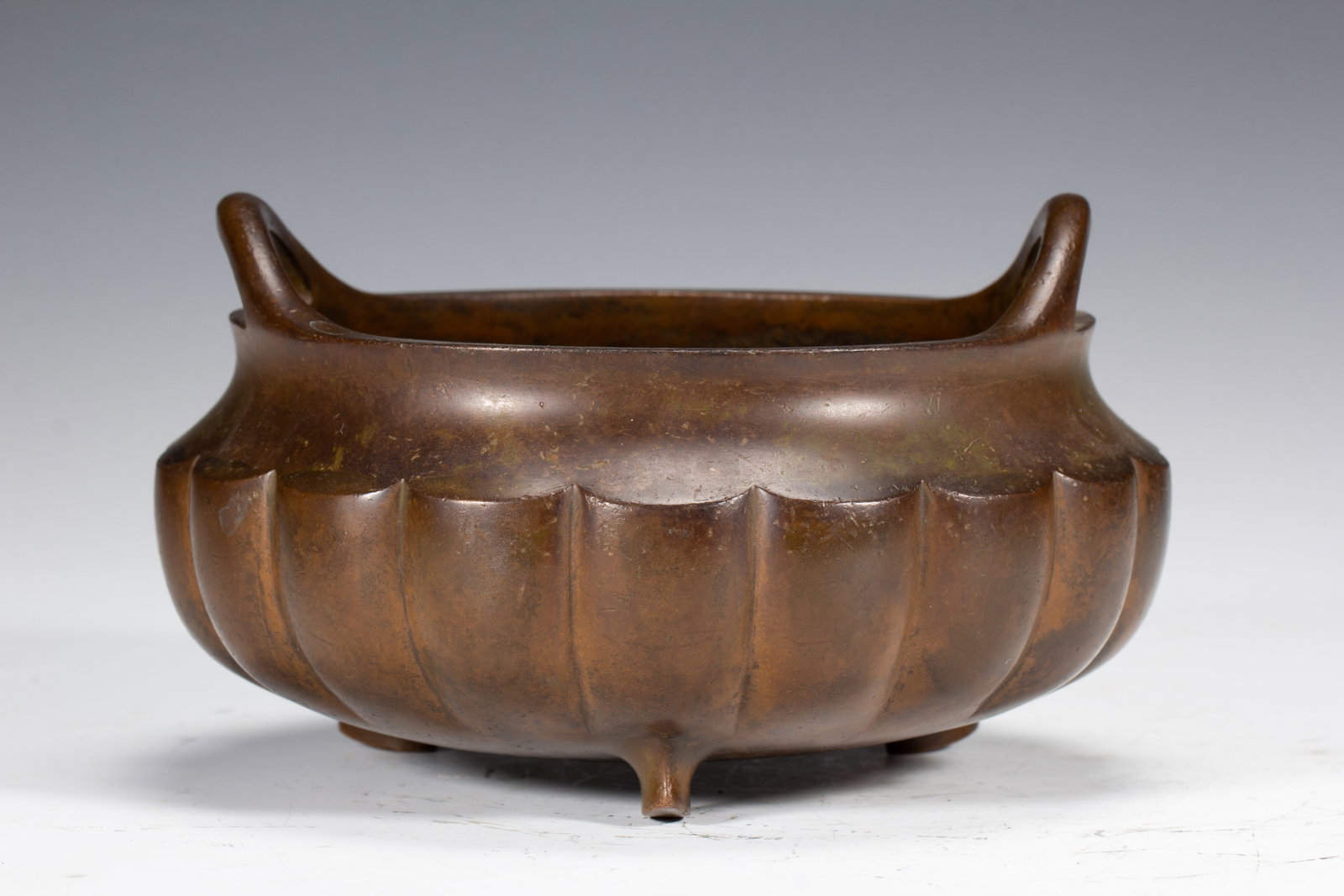 An Exquisite Copper Tripod Melon-Ribbed Censer With Bridge-Shaped Ears (1 of 7)