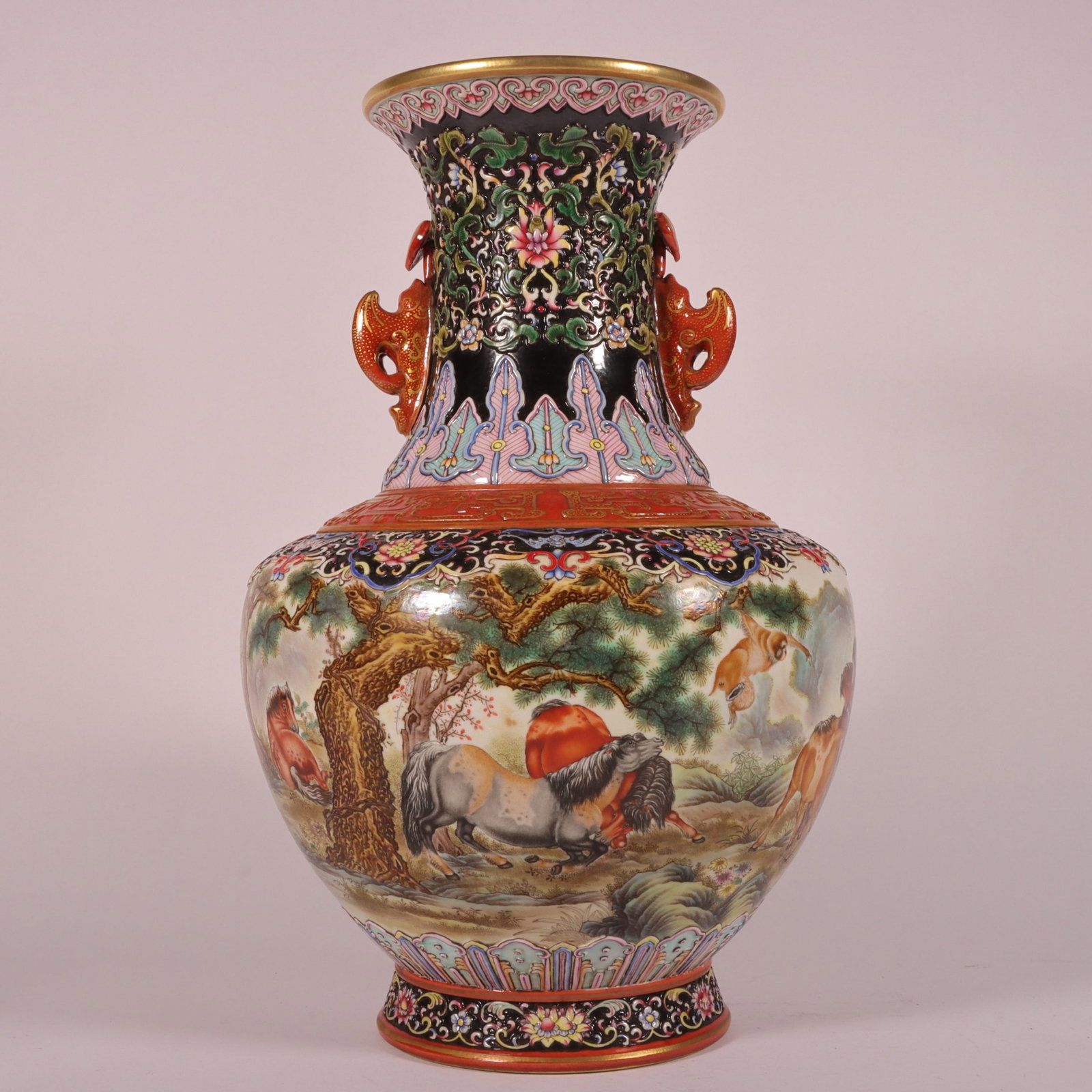 A Fine Carved Gilt Famille Rose Double-Eared Vase,Interlocking Lotus and Continuous Hundred Horses: A Fine Carved Gilt Famille Rose Double-Eared Vase,Interlocking Lotus and Continuous Hundred Horses,Qing Dynasty,China,Qianlong Six-character Mark,Size:12.1inx7.5in,粉彩雕刻