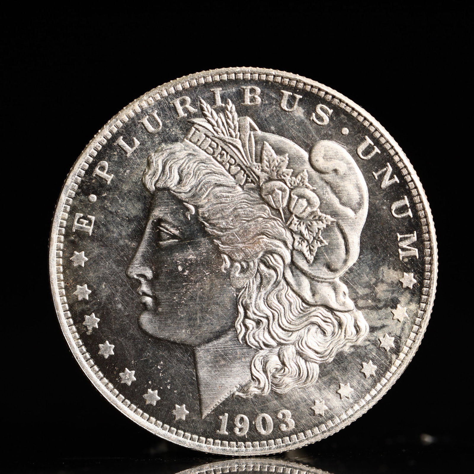 USA Morgan Dollar 1903 Coin: Obv: profile bust with date below and E PLURIBUS UNUM legend and stars around. Rev: eagle with In God we trust above within wreath with UNITED STATES OF AMERICA ONE DOLLAR legend. IN GOD WE TRUST / LI