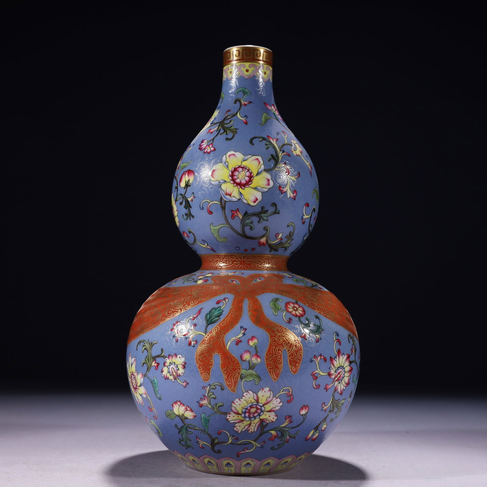 An Exquisite Blue Ground Famille-Rose Painted Gold Lotus Pattern Gourd-Shaped Vase: An Exquisite Blue Ground Famille-Rose Painted Gold Lotus Pattern Gourd-Shaped Vase,Qing Dynasty,China,Qianlong Six-character Mark,Size:5.5inx11in,Weight:1300g 蓝地粉彩描&