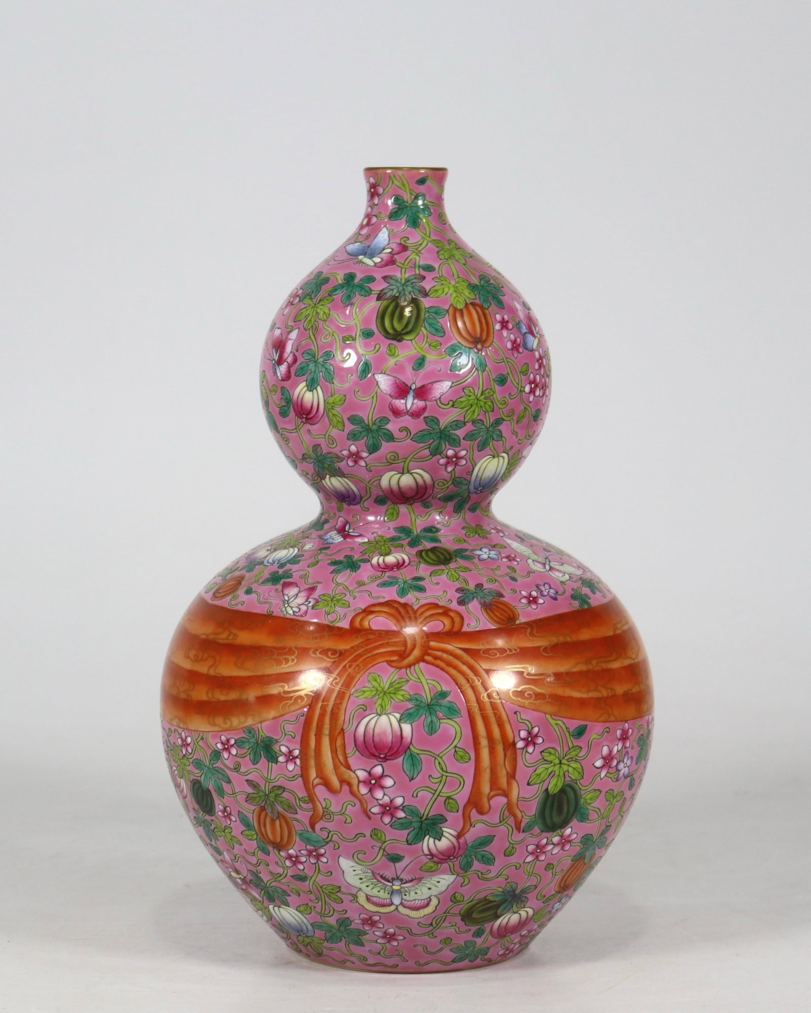 A fine famille rose scrolling fruit and ribbon double-gourd vase: A fine famille rose scrolling fruit and ribbon double-gourd vase, Qing Dynasty, China, with six-character Qianlong reign mark, Size:11inx6.5in 粉彩缠枝瓜果系&