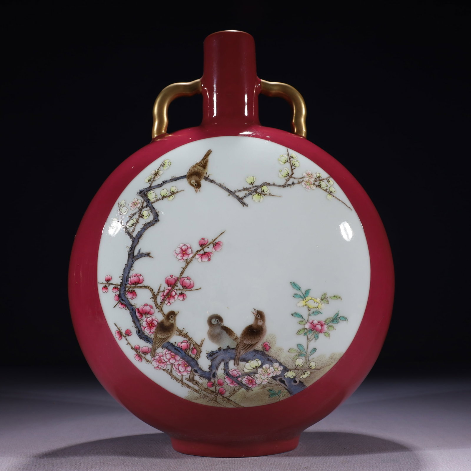 An Exquisite Ruby Red-Glazed Famille-Rose Painted Gold Flower and Bird Pattern Double-Ears Vase: An Exquisite Ruby Red-Glazed Famille-Rose Painted Gold Flower and Bird Pattern Double-Ears Vase,Qing Dynasty,China,Qianlong Six-character Mark,Size:9.4inx4.7inx13in,Weight:2650g
