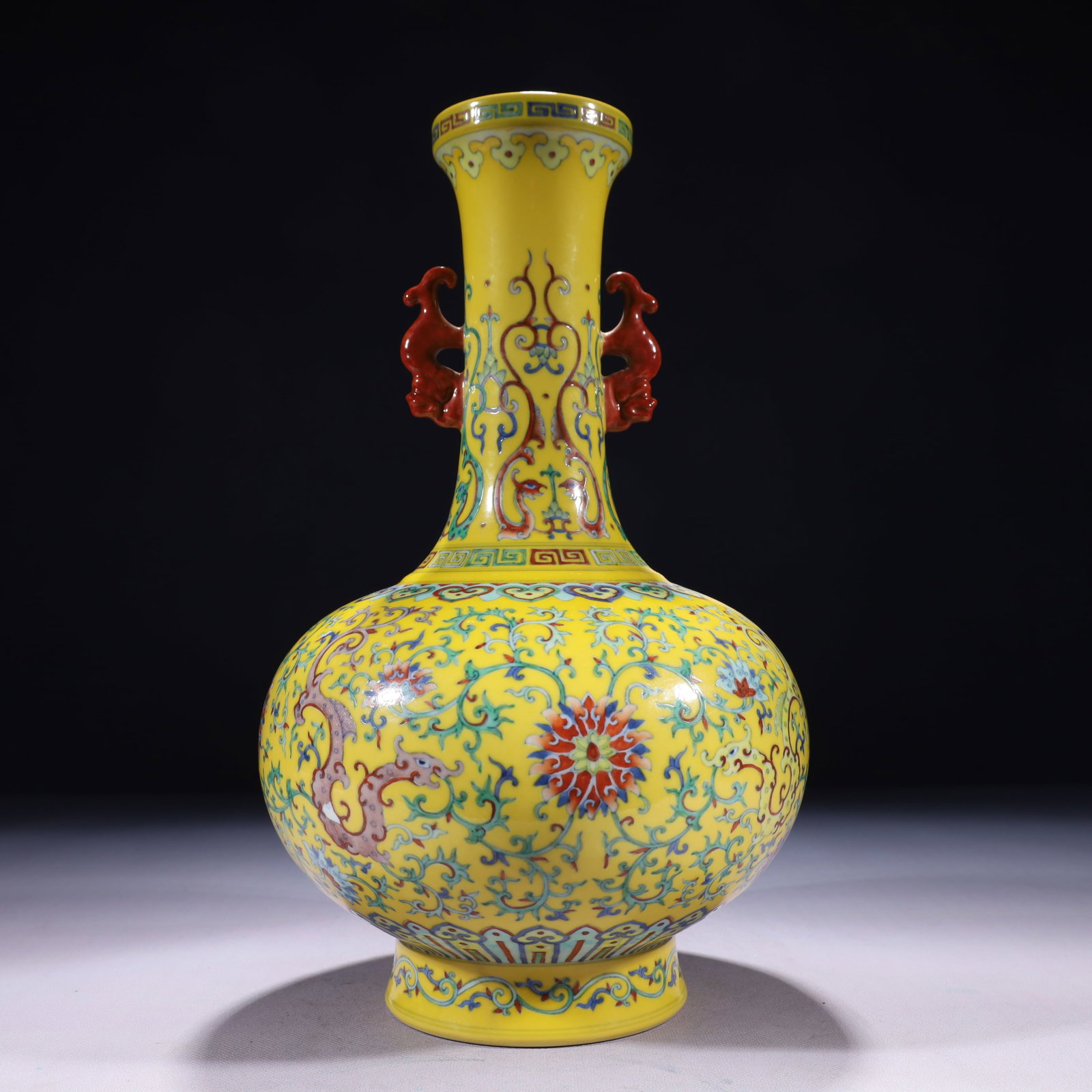 An Exquisite Yellow Ground Famille-Rose Lotus Pattern Double-Ears Vase: An Exquisite Yellow Ground Famille-Rose Lotus Pattern Double-Ears Vase 黄地粉彩缠枝莲纹双耳瓶,中国清代,乾
