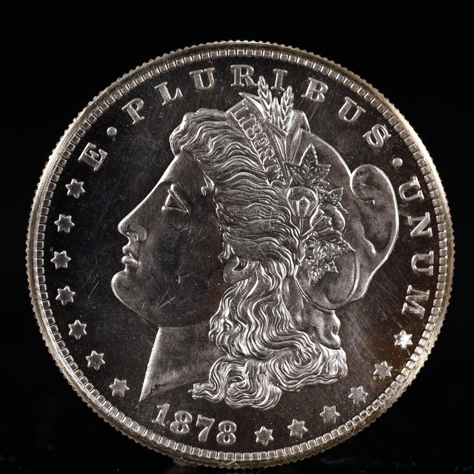 USA Morgan Dollar 1878 Coin: Obv: profile bust with date below and E PLURIBUS UNUM legend and stars around. Rev: eagle with In God we trust above within wreath with UNITED STATES OF AMERICA ONE DOLLAR legend. IN GOD WE TRUST / LI