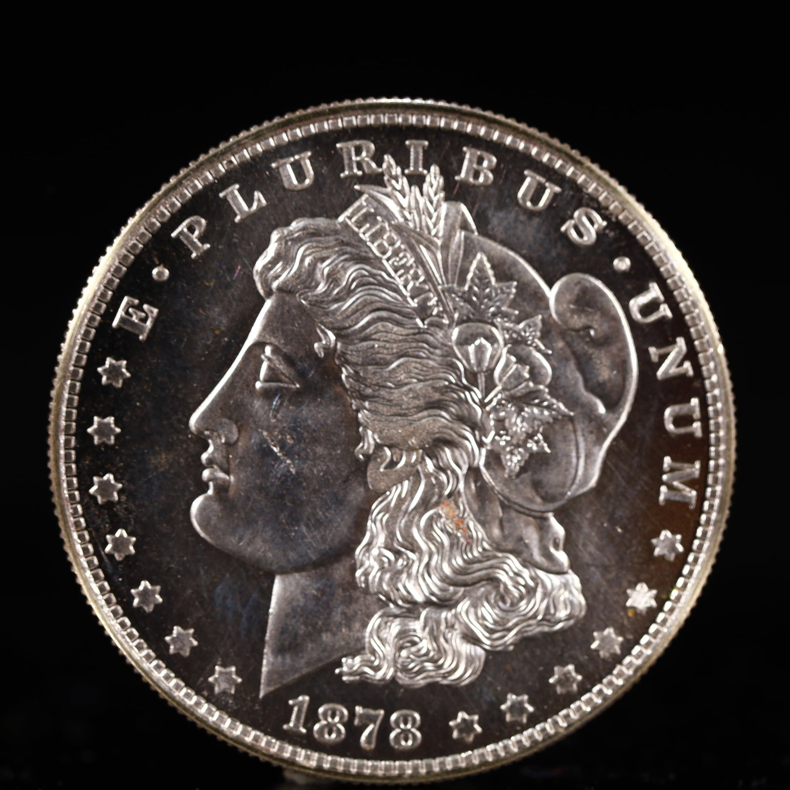 USA Morgan Dollar 1878 Coin: Obv: profile bust with date below and E PLURIBUS UNUM legend and stars around. Rev: eagle with In God we trust above within wreath with UNITED STATES OF AMERICA ONE DOLLAR legend. IN GOD WE TRUST / LI