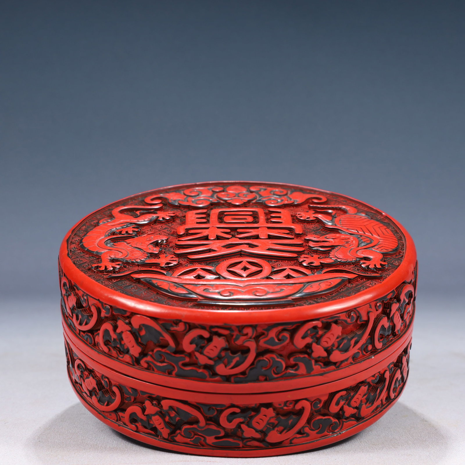 An Exquisite Carved Red Lacquer Bats and Dragon Pattern Cover Box: An Exquisite Carved Red Lacquer Bats and Dragon Pattern Cover Box,Qing Dynasty, China,Size:7.1inx2.8in,Weight:600g 剔红漆蝙蝠龙纹盖盒,中