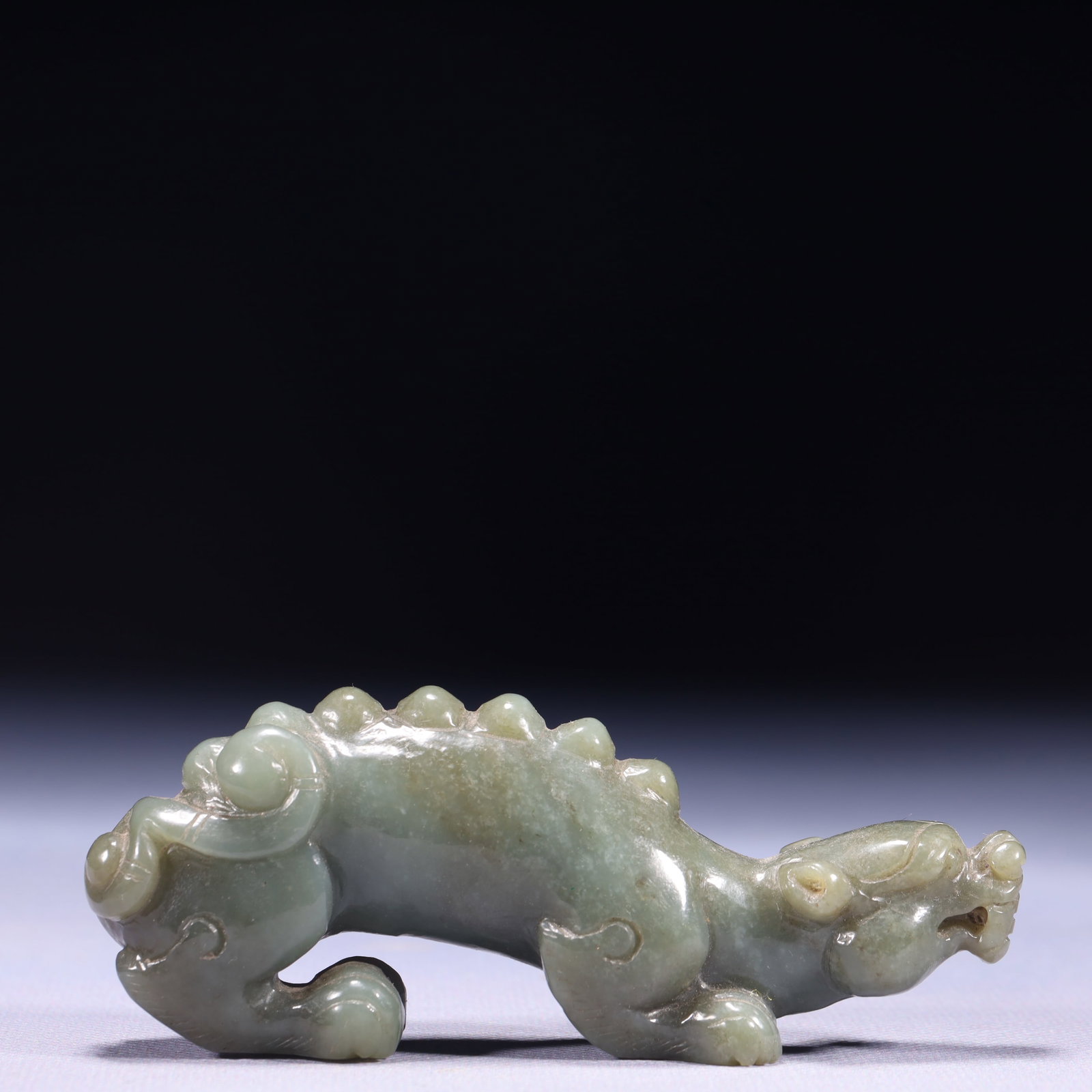 An Exquisite Green Jade Beast Ornament: An Exquisite Green Jade Beast Ornament,Qing Dynasty,China,Size:4.3inx0.8inx1.8in,Weight:139g 青玉兽摆件,中国清代