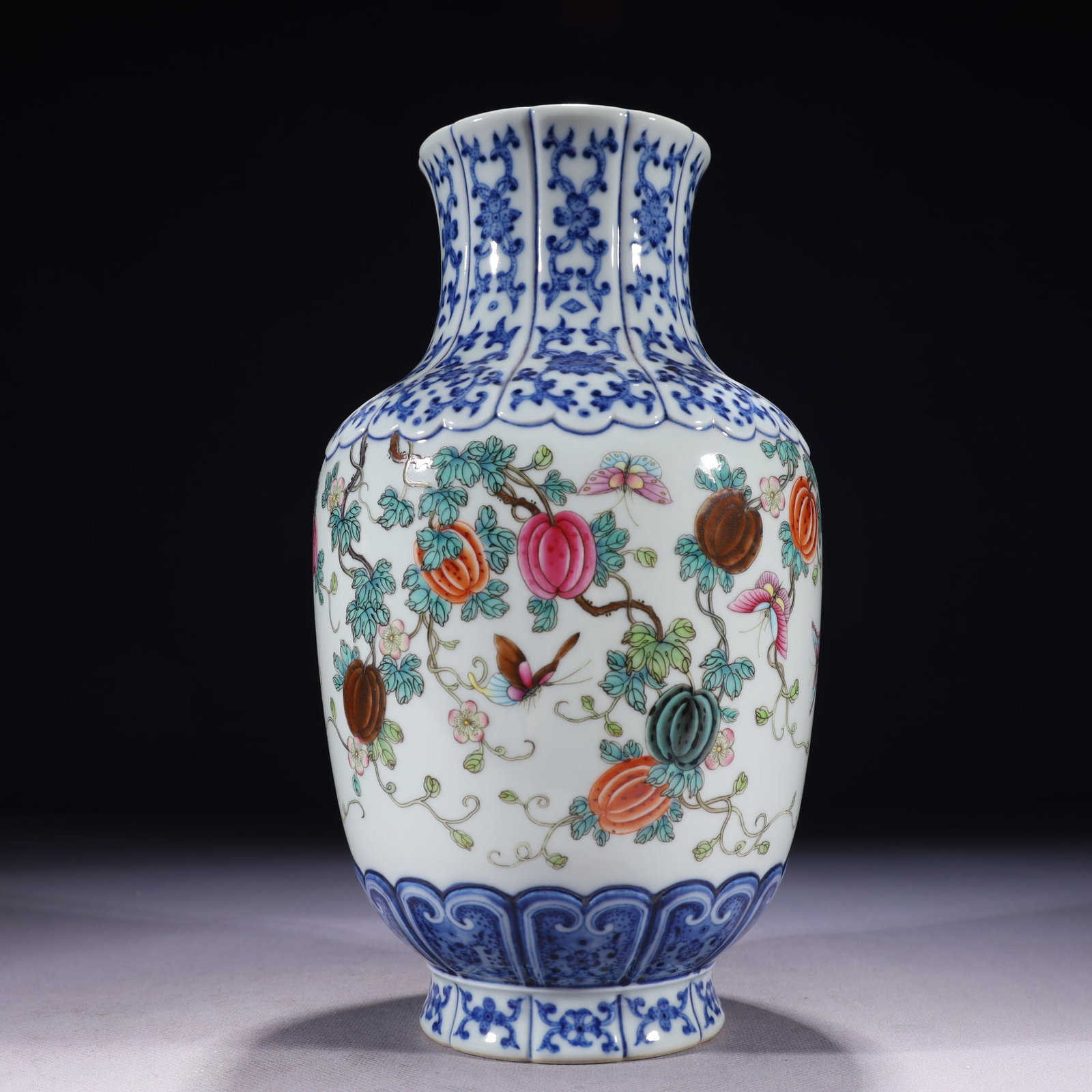 An Exquisite Blue and White Famille-Rose Melon and Butterfly Pattern Vase: An Exquisite Blue and White Famille-Rose Melon and Butterfly Pattern Vase,Qing Dynasty,China,Qianlong Six-character Mark,Size:5.5inx10.6in,Weight:1450g