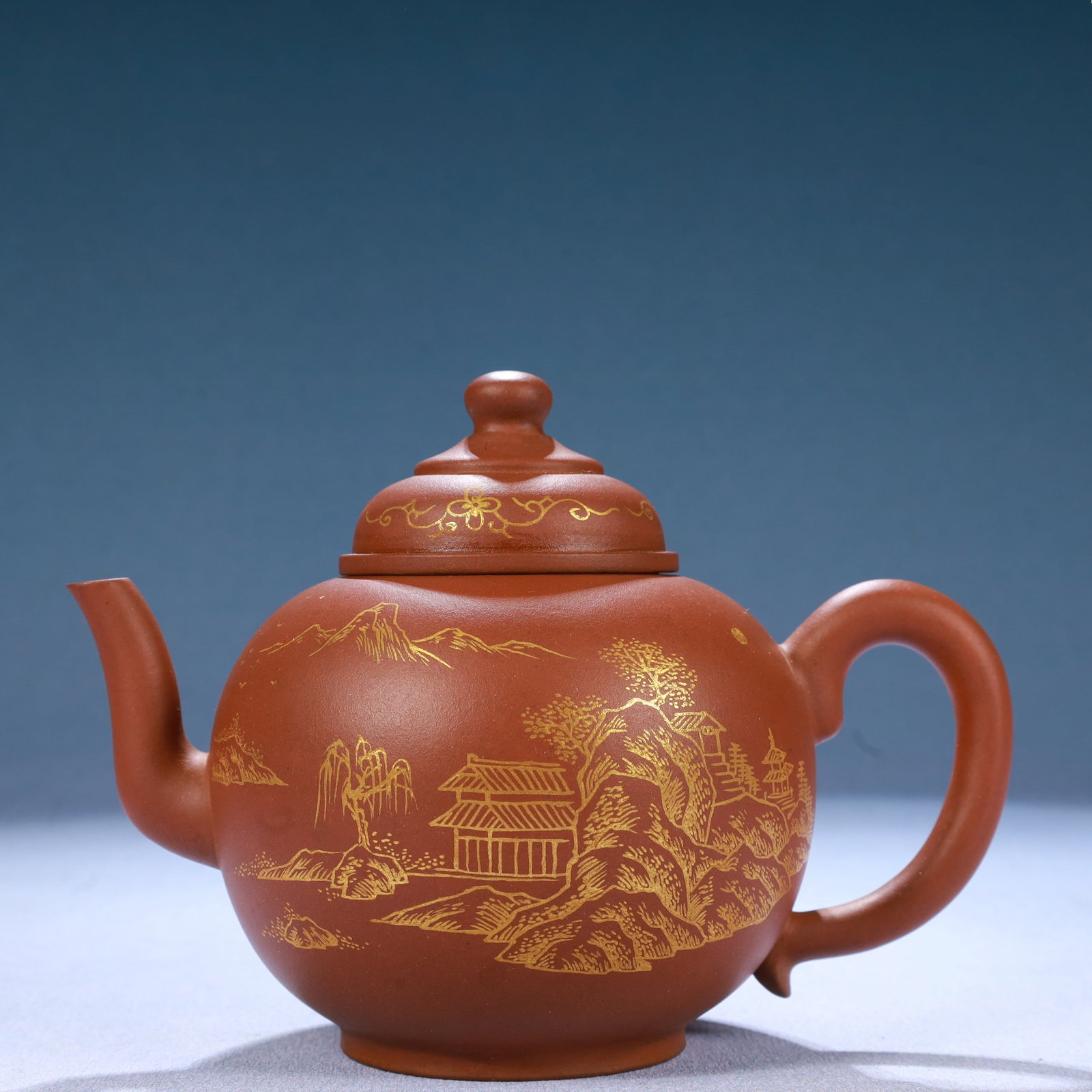 A Yixing Clay Gilded 'Landscape' Ewer With Poem Inscriptions: A Yixing Clay Gilded 'Landscape' Ewer With Poem Inscriptions. Gilded on the exterior with mountains,ancient Chinese architecture and trees. Chinese Qing Dynasty. Qianlong Six-Character Mark.