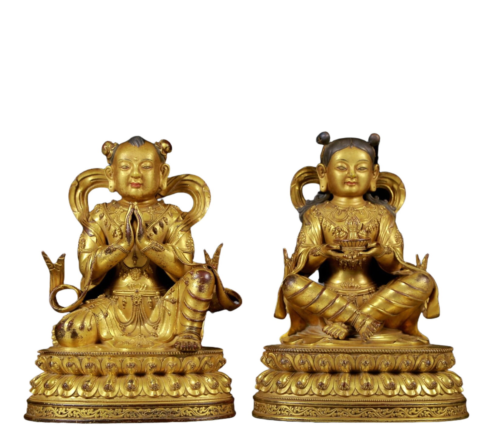 Two solemn gilt bronze figures: Two solemn gilt bronze figures Ming Dynasty, China. The figures have clear facial contours and vivid expressions. Costumes, fabric textures and decorative details are crafted to life. The works are