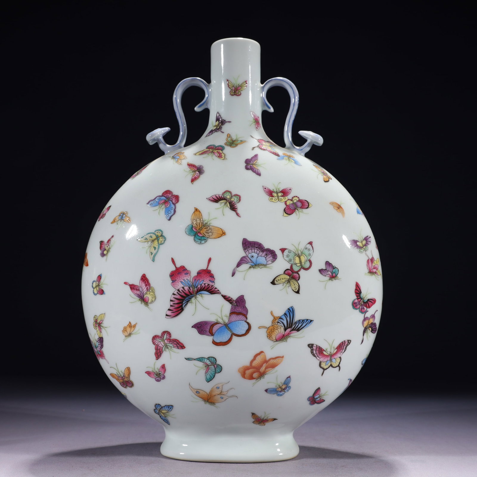 An Exquisite Famille-Rose Butterfly Pattern Double-Ears Vase: An Exquisite Famille-Rose Butterfly Pattern Double-Ears Vase,Qing Dynasty,China,Qianlong Six-character Mark,Size:9.1inx4.3inx13.8in,Weight:2400g 粉彩蝴蝶纹双耳
