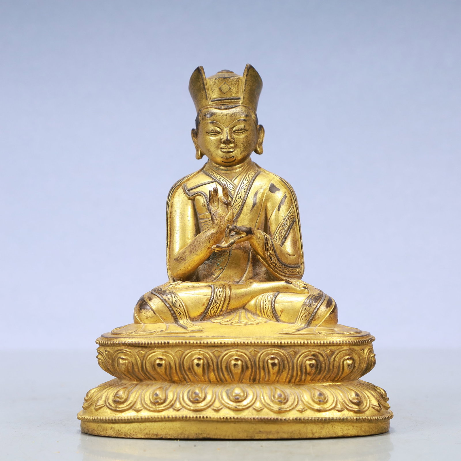 A Exquisite Gilt Bronze Statue of Guru: A Exquisite Gilt Bronze Statue of Guru Ming Dynasty, China Size:5.5inx3.5inx8.3in Weight:1465g铜鎏金上师 中国明代 Size:14cmx9cmx21cm Weight:1465g
