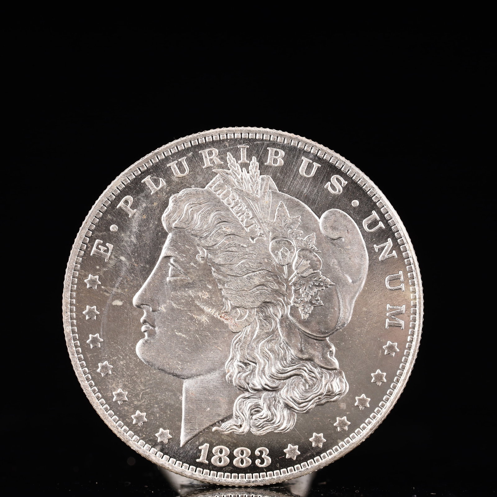 USA Morgan Dollar 1883 Coin: Obv: profile bust with date below and E PLURIBUS UNUM legend and stars around. Rev: eagle with In God we trust above within wreath with UNITED STATES OF AMERICA ONE DOLLAR legend. IN GOD WE TRUST /