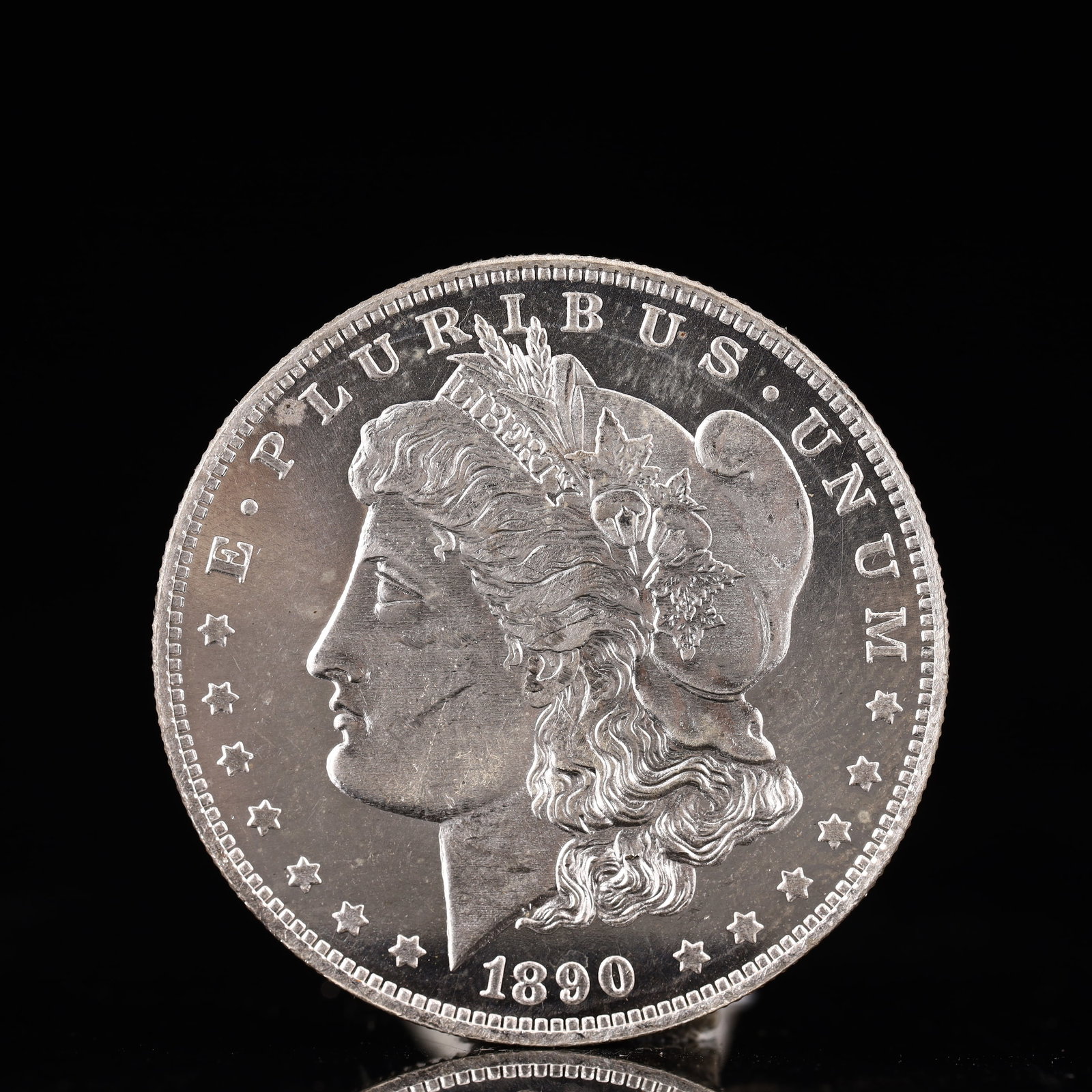 USA Morgan Dollar 1890 Coin: Obv: profile bust with date below and E PLURIBUS UNUM legend and stars around. Rev: eagle with In God we trust above within wreath with UNITED STATES OF AMERICA ONE DOLLAR legend. IN GOD WE TRUST /