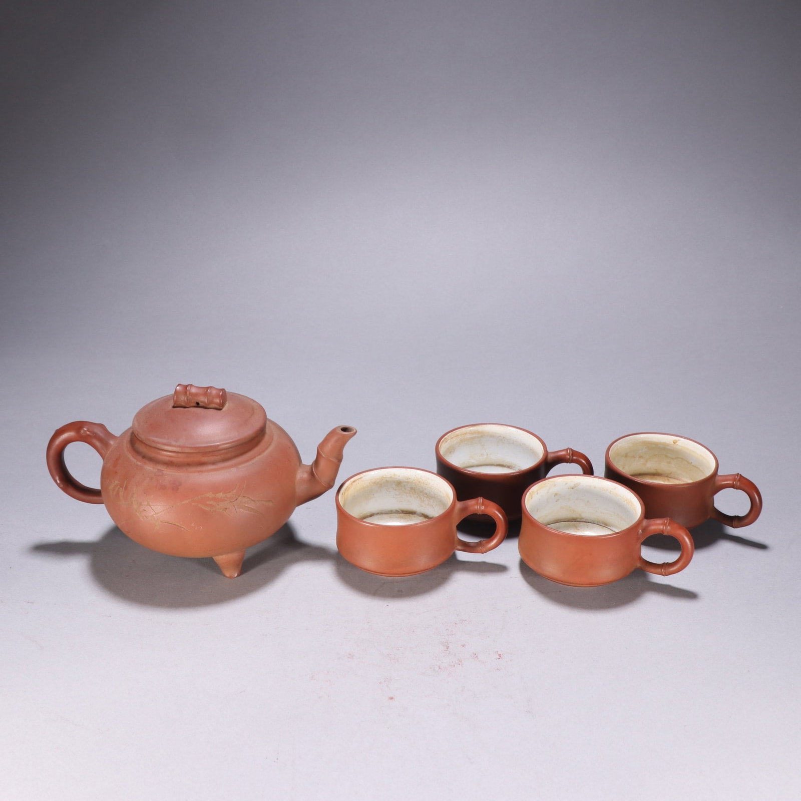 A Set of Fine Purple Sands Bamboo Pattern Teaware: A Set of Fine Purple Sands Bamboo Pattern Teaware,Qing Dynasty,China,With Mark,Size:(Teapot)4.3inx7.3in,(Cup)1.7inx4.1in一套紫砂竹纹茶具,中国