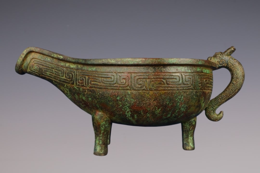 An Archaic Bronze Dragon-head Tripod Cup,With Inscription: An Archaic Bronze Dragon-head Tripod Cup,With Inscription,W.Zhou ,