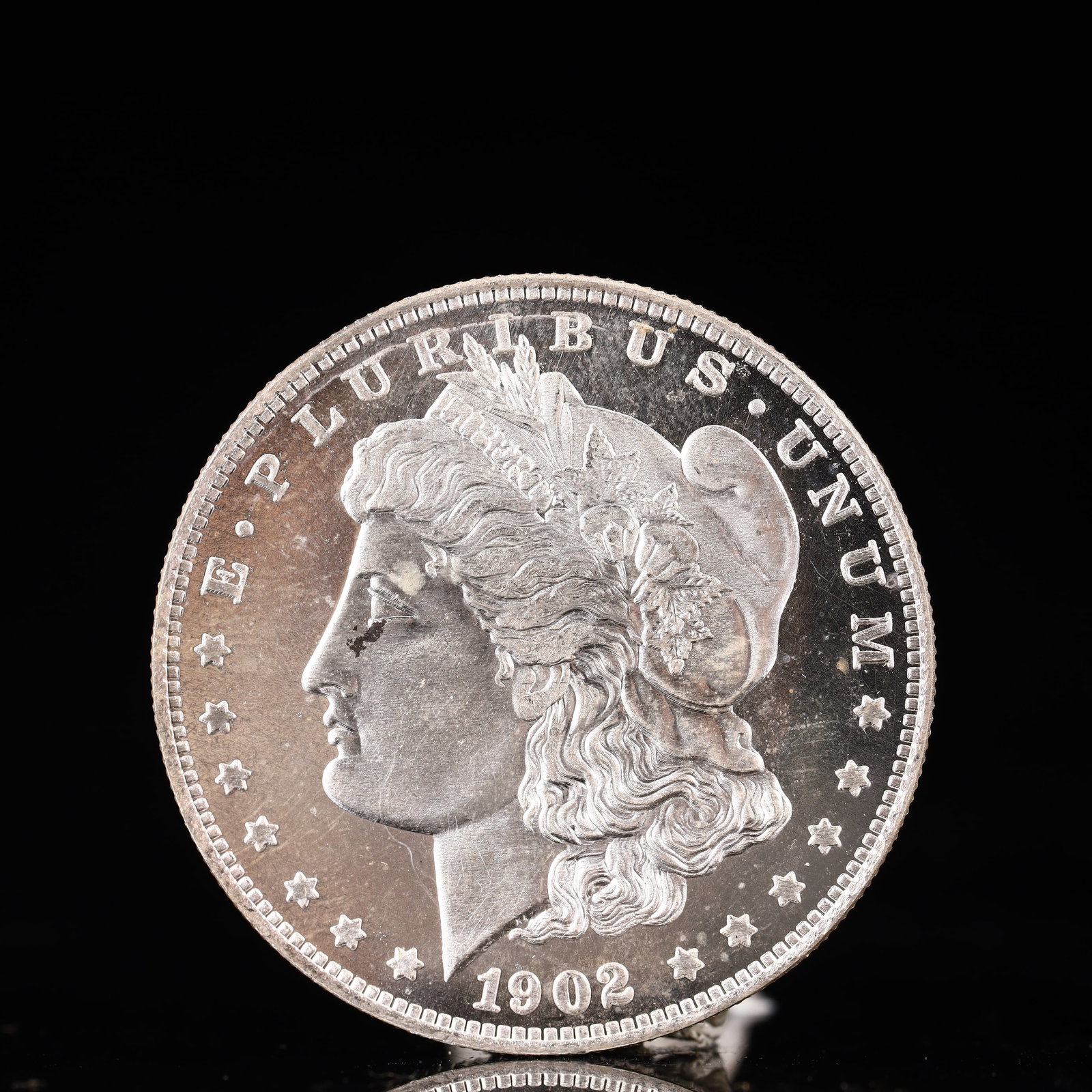 USA Morgan Dollar 1902 Coin: Obv: profile bust with date below and E PLURIBUS UNUM legend and stars around. Rev: eagle with In God we trust above within wreath with UNITED STATES OF AMERICA ONE DOLLAR legend. IN GOD WE TRUST /