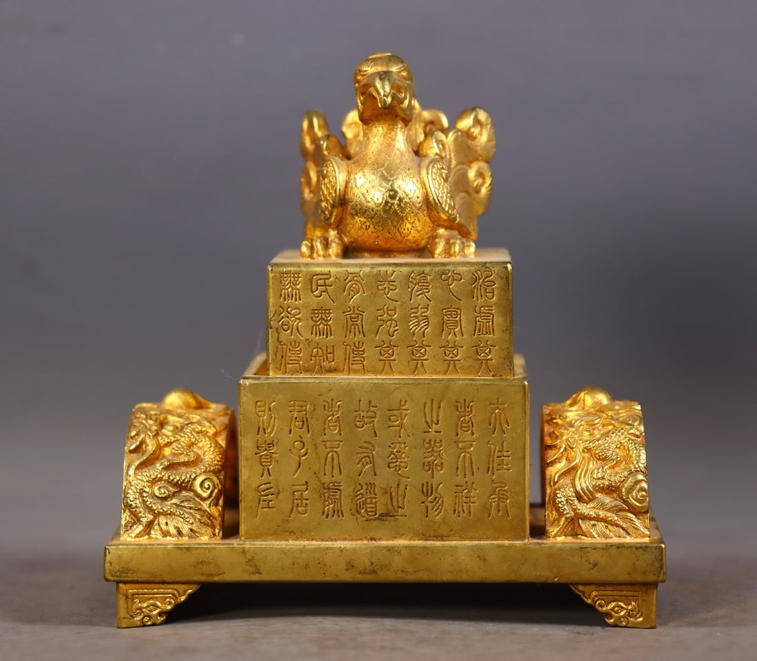 An Exquisite Gilt Bronze Dragon and Phoenix Pattern Seal: An Exquisite Gilt Bronze Dragon and Phoenix Pattern Seal,Qing Dynasty,China,Size:(Total)5.7in,(Base)2.6inx5.3inx2.8in,(Seal)3.3inx2.4inx2.4in,Total