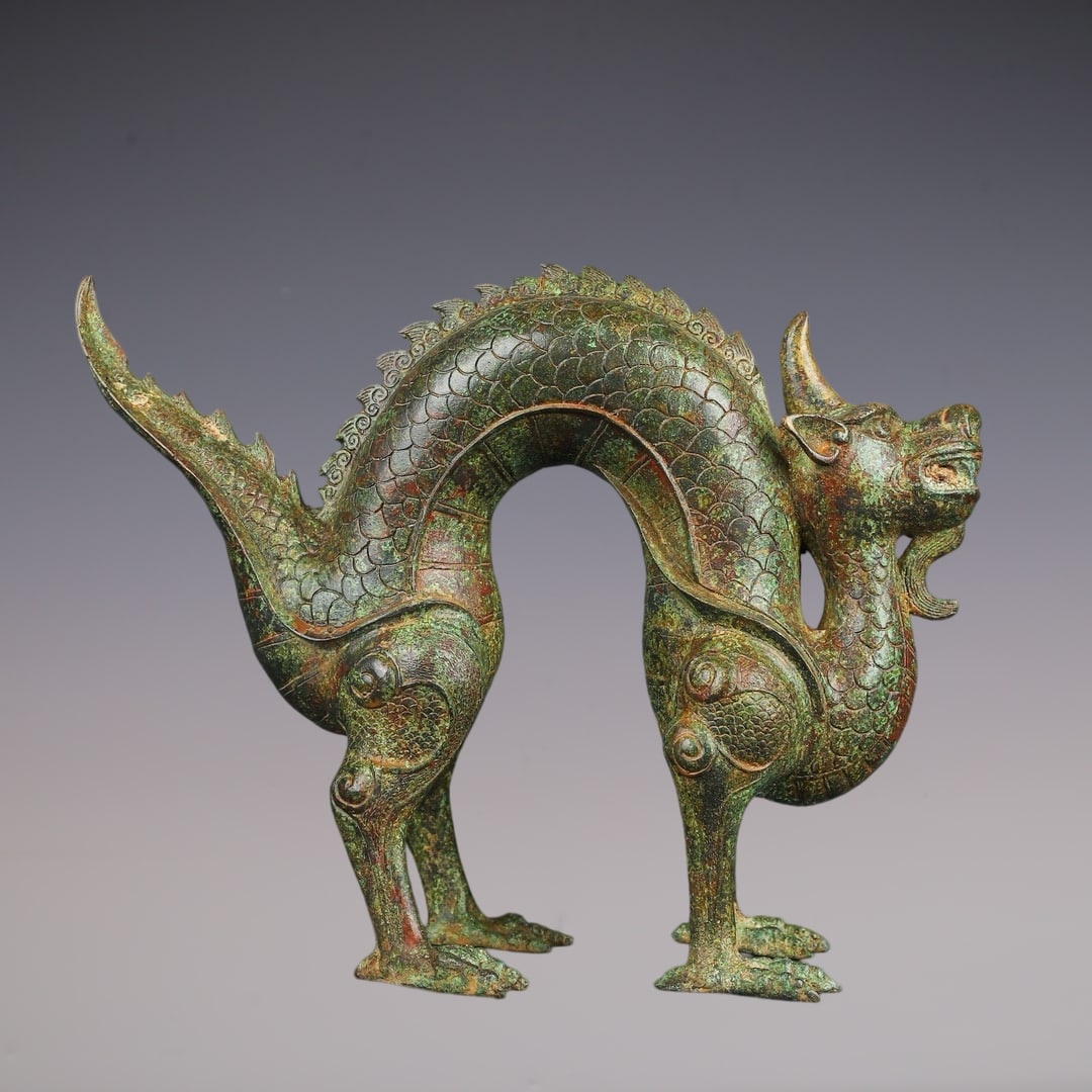 An Archaic Bronze Dragon Ornament: An Archaic Bronze Dragon Ornament,Han Dynasty, China,Size:12.6inx10.2in,Weight:3100g青铜龙摆件,中国汉代,Size:32cmx26cm,Weight:3100g
