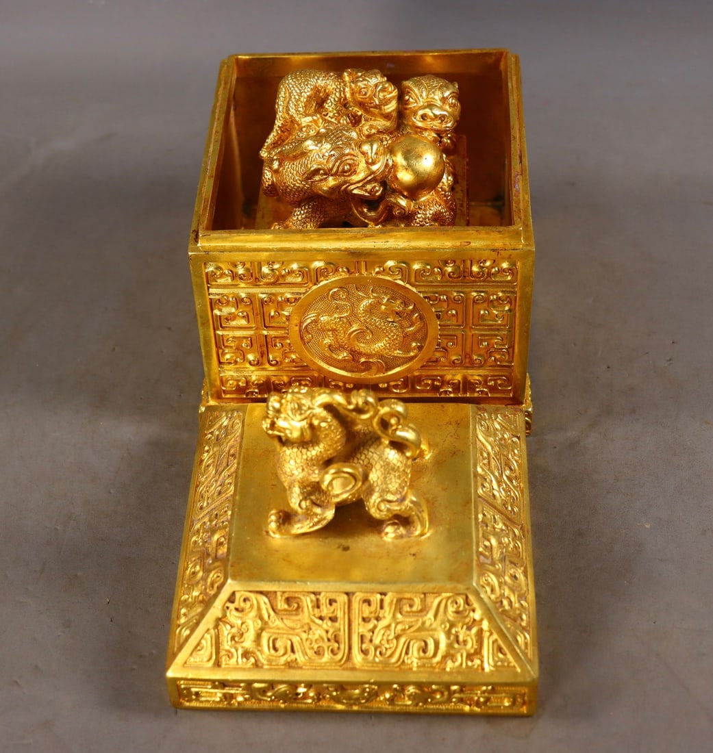 An Exquisite Gilt Bronze Auspicious Cloud and Dragon Pattern Beast-Shaped Seal: An Exquisite Gilt Bronze Auspicious Cloud and Dragon Pattern Beast-Shaped Seal,Qing Dynasty,China,Size:7.1inx4.7inx4.7in,(Seal)3.9inx3.1inx3.1in,Total