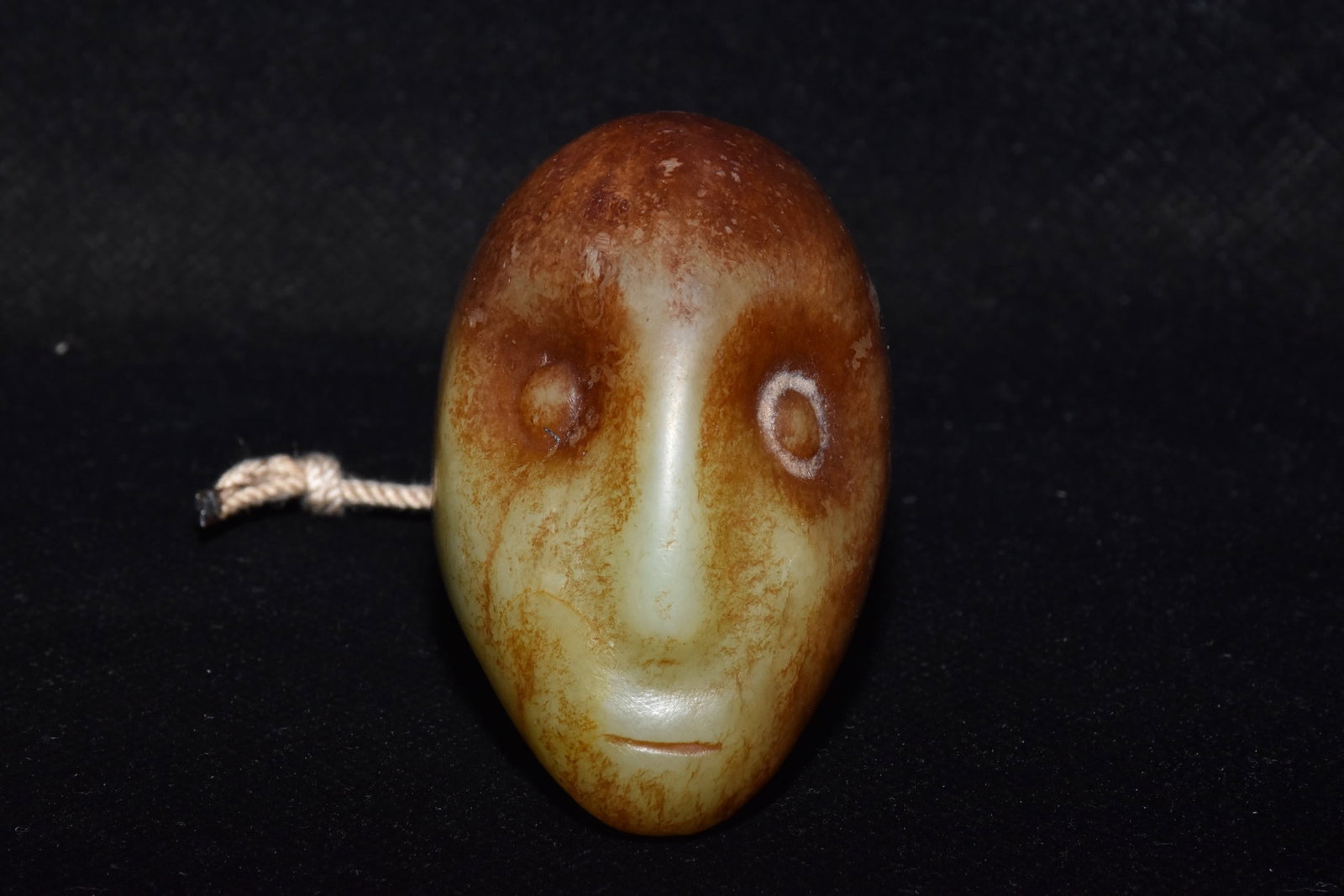 An Exquisite White Jade Figure-Face Pattern Ornament: An Exquisite White Jade Figure-Face Pattern Ornament,Hongshan Culture,Size:2.6inx2.1in,Weight:170g白玉人面纹摆件,红山文化,Size:6.5cmx5