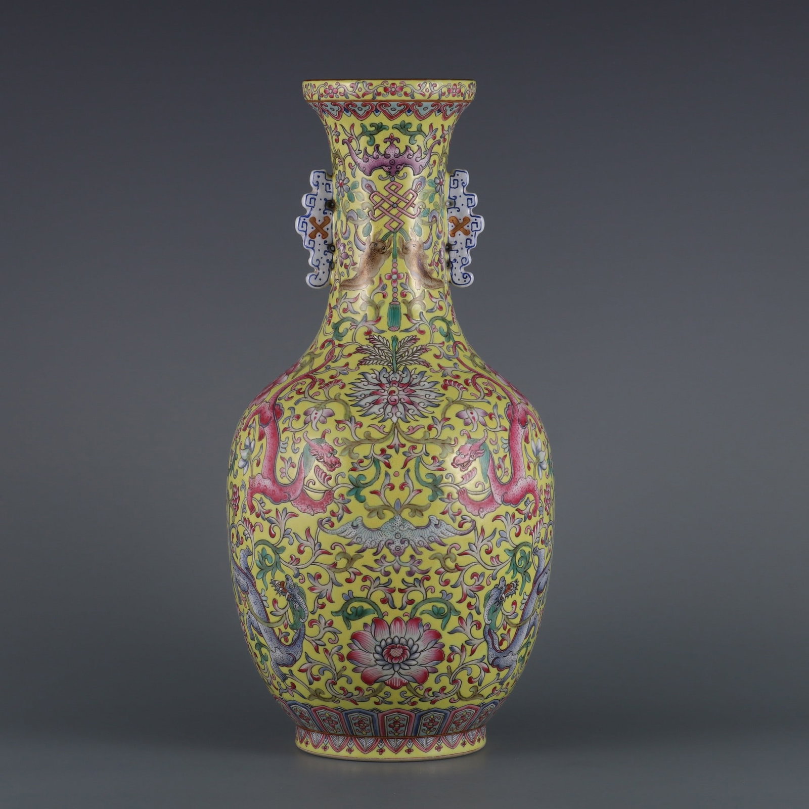 A Rare Yellow Ground Famille-Rose Painted Gold Lotus and Dragon Pattern Double-Ears Vase: A Rare Yellow Ground Famille-Rose Painted Gold Lotus and Dragon Pattern Double-Ears Vase,Qing Dynasty, China,Qianlong Six-character Mark,Size:13.6inx3.3inx7.1in黄地粉彩描