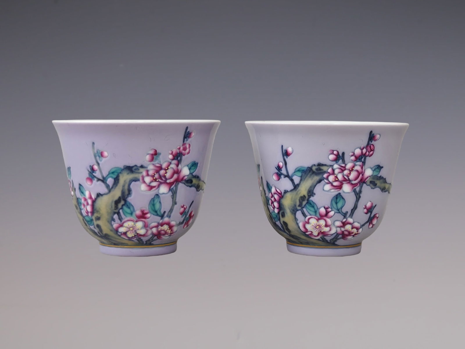 A Pair of Exquisite Blue and White Famille-Rose Purple Ground Plum Blossom Pattern Cups: A Pair of Exquisite Blue and White Famille-Rose Purple Ground Plum Blossom Pattern Cups,Qing Dynasty, China,Yongzheng Six-character Mark,Size:2inx2.4in一对青花粉彩&