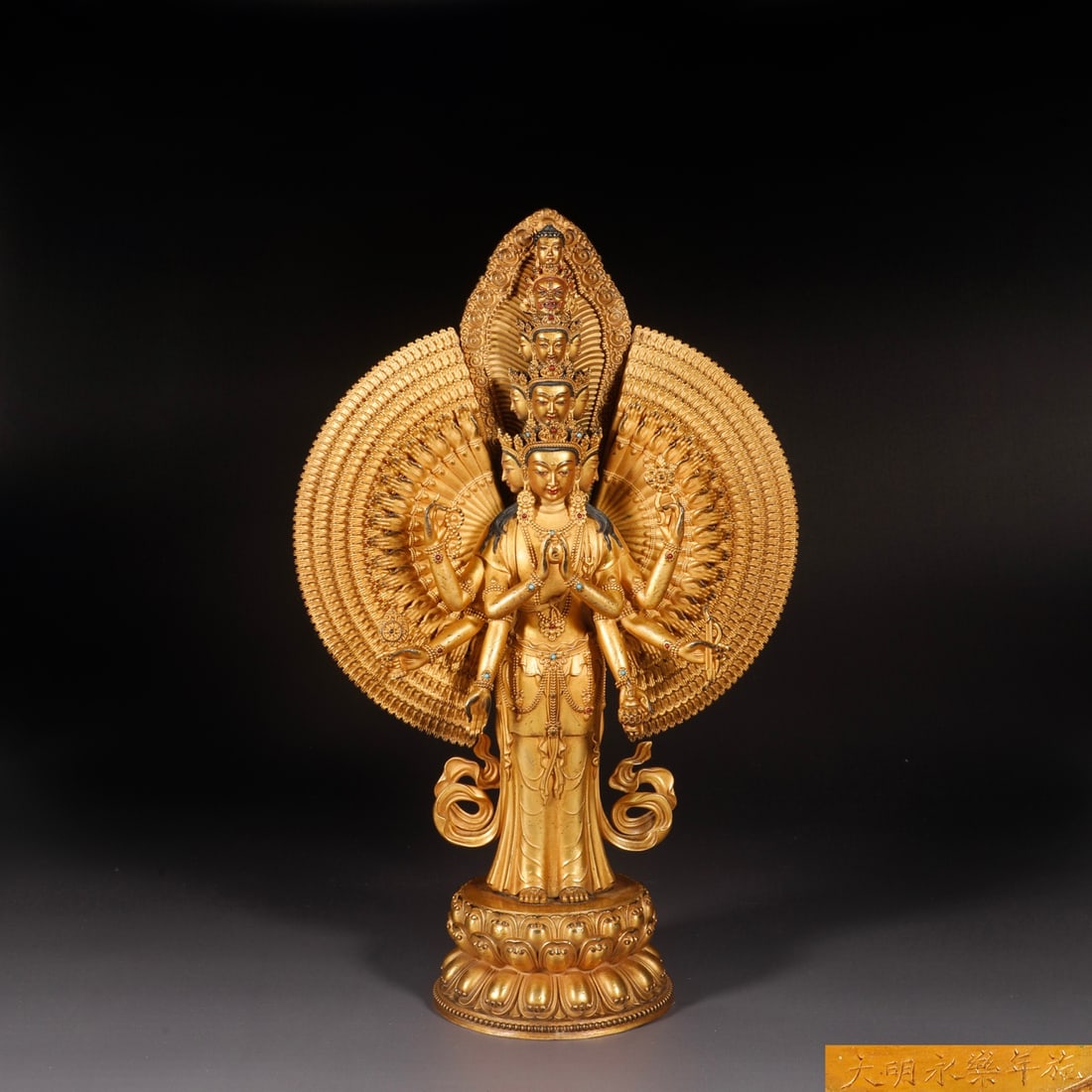 A Solemn Gilt Bronze Statue of Thousand-hand Guanyin,Inlaid Turquoise: A Solemn Gilt Bronze Statue of Thousand-hand Guanyin,Inlaid Turquoise,Ming Dynasty,China,Yongle Six-character Mark,Size:13.1inx8.5in,Weight:2750g铜鎏金千手观音