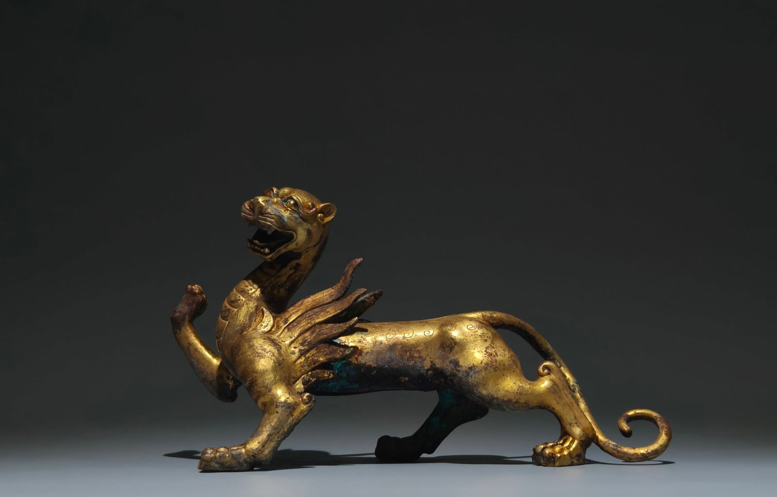 An Exquisite Gilt Bronze Auspicious Beast Ornament: An Exquisite Gilt Bronze Auspicious Beast Ornament,Han Dynasty, China,Size:6.3inx11inx3.9in 铜鎏金瑞兽摆件,中国汉代