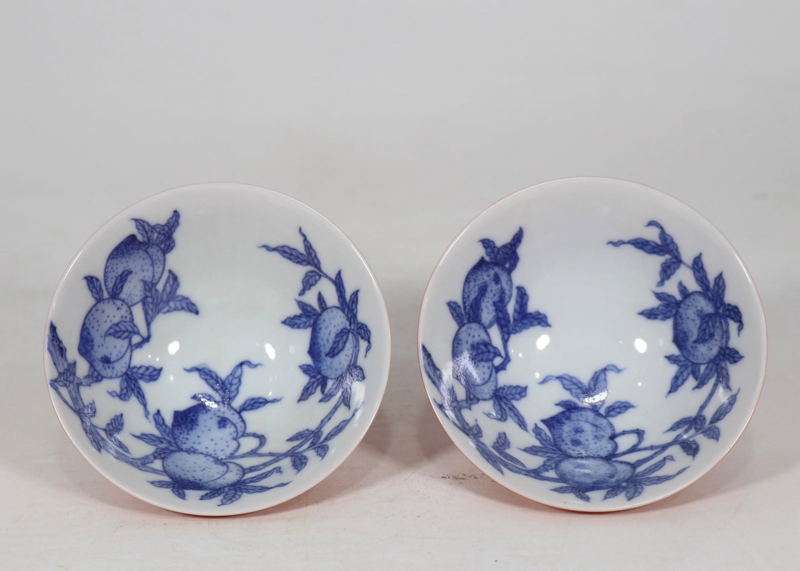 An Exquisite Coral Red Glazed Blue and White Peach Pattern Cup: An Exquisite Coral Red Glazed Blue and White Peach Pattern Cup,Qing Dynasty, China,Yongzheng Six-character Mark,Size:1.8inx3.9in珊瑚红釉青花寿桃纹