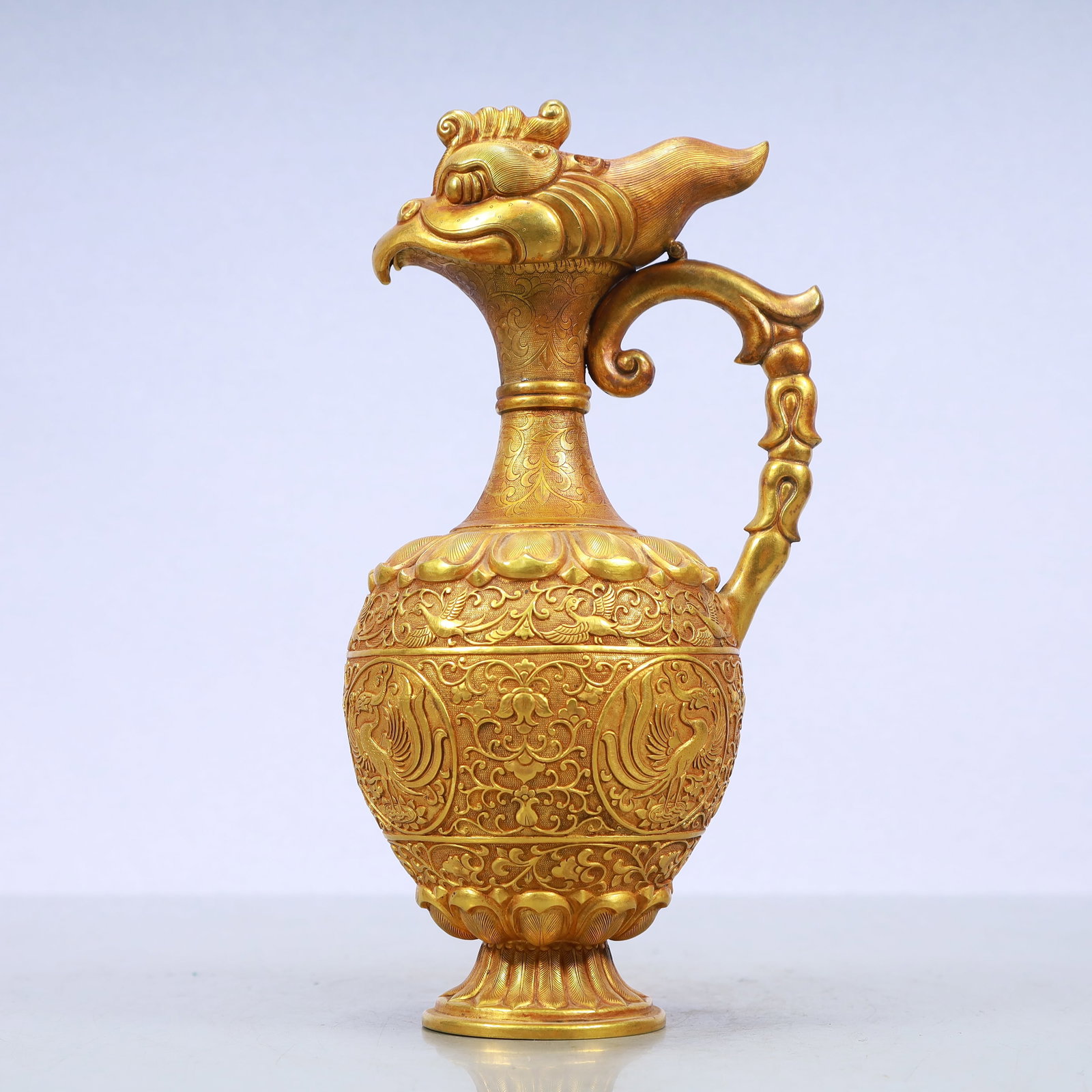 A Exquisite Gilt Bronze Lotus Pattern Phoenix Pattern Ewer: A Exquisite Gilt Bronze Lotus Pattern Phoenix Pattern Ewer Qing Dynasty, China Size:5.1inx3.9inx9.8in Weight:750g铜鎏金缠枝莲纹凤纹执壶