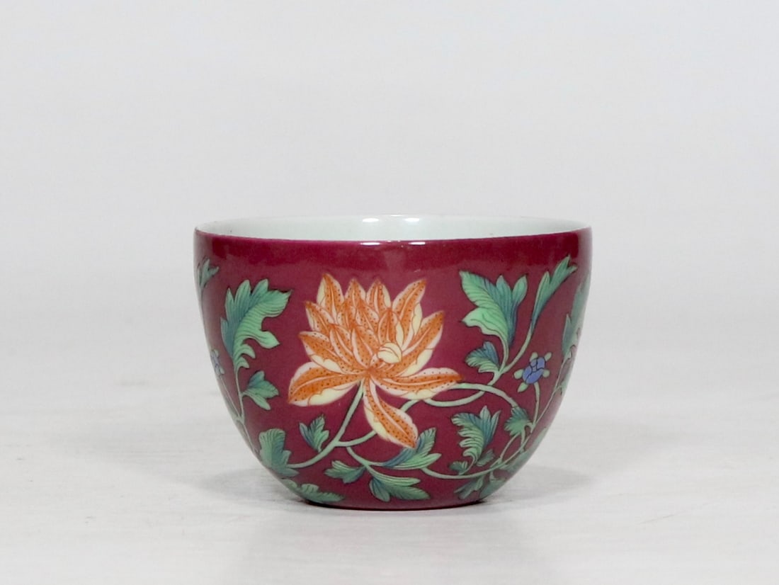 An Exquisite Enamel Ruby Red-Ground Lotus Pattern Cup: An Exquisite Enamel Ruby Red-Ground Lotus Pattern Cup,Qing Dynasty, China,Yongzheng Four-character Mark,Size:2inx2.8in珐琅彩胭脂红地缠枝莲&#