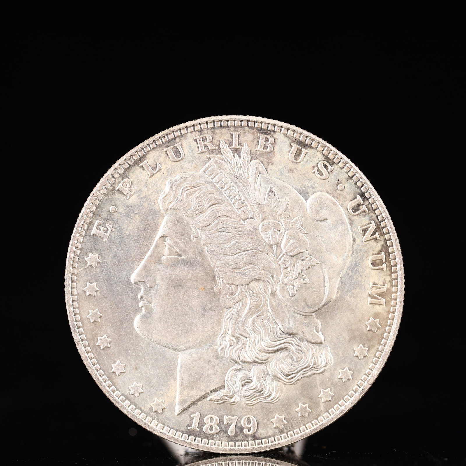 USA Morgan Dollar 1879 Coin: Obv: profile bust with date below and E PLURIBUS UNUM legend and stars around. Rev: eagle with In God we trust above within wreath with UNITED STATES OF AMERICA ONE DOLLAR legend. IN GOD WE TRUST /