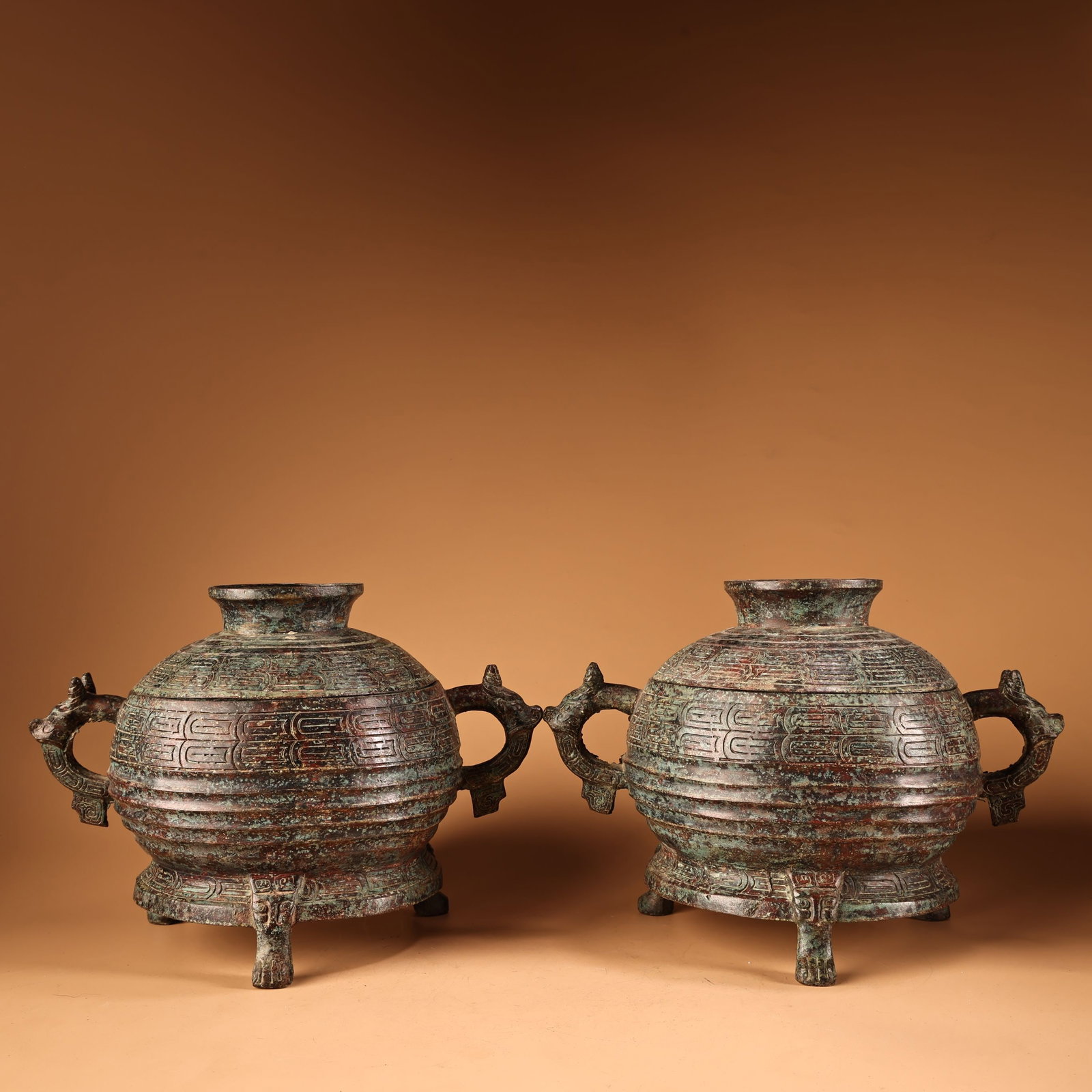 A Pair of Archaic Bronze Beast-Ears Tripod ritual vessels: A Pair of Archaic Bronze Beast-Ears Tripod ritual vessels,Qing Dynasty,China,Size:9.1inx11.8in,Total