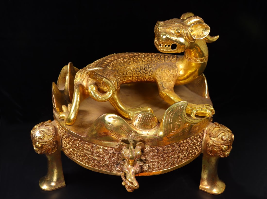 A Huge Gilt Bronze Auspicious Beast Ornament,With Tripod Base,With Inscription: A Huge Gilt Bronze Auspicious Beast Ornament,With Tripod Base,With Inscription,the Warring States period in China,Size:24.8inx19.3in,Weight:21850g铜鎏金瑞兽摆ߥ