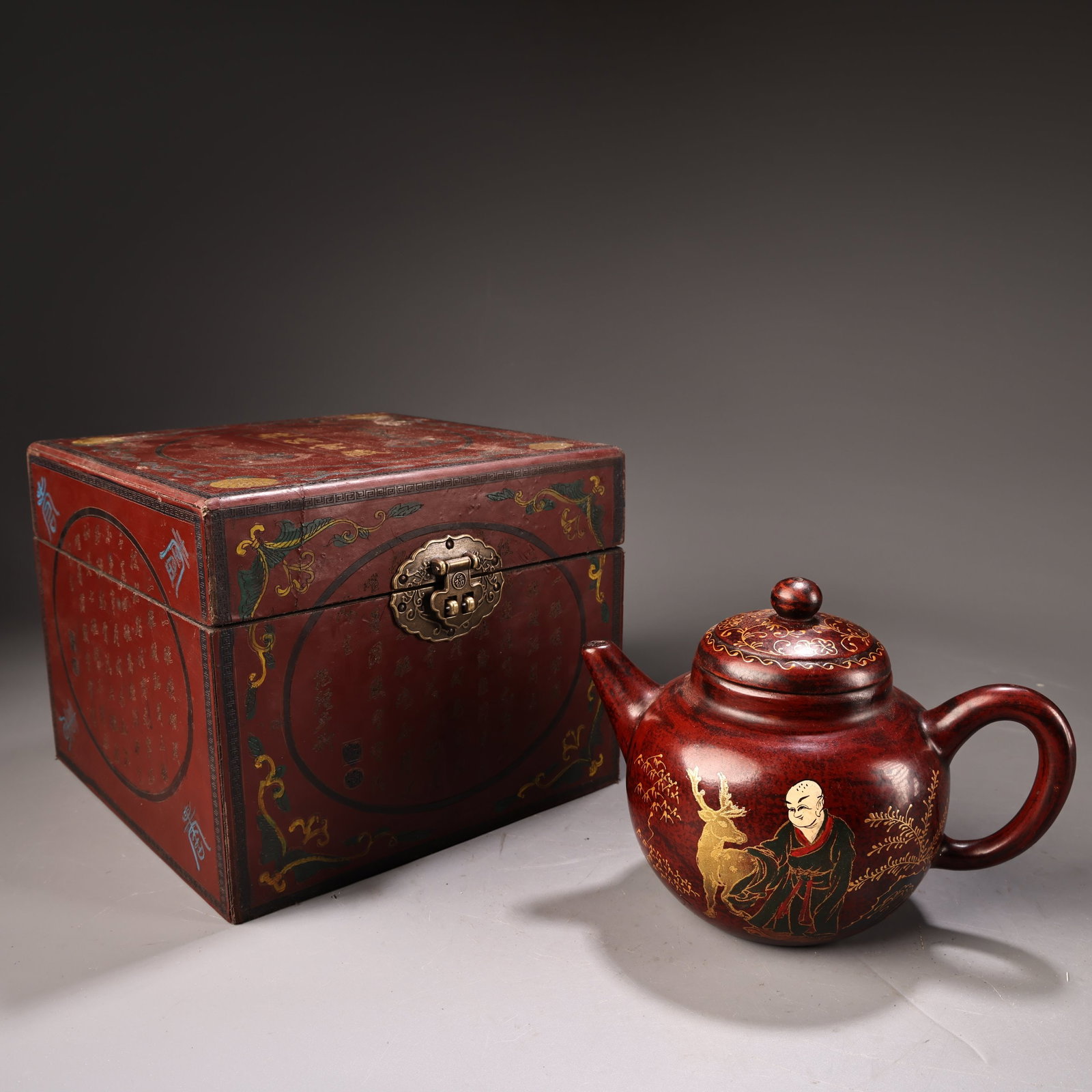 An Exquisite Purple Sands Painted Gold Painted Color Figure and Deer Pattern Teapot: An Exquisite Purple Sands Painted Gold Painted Color Figure and Deer Pattern Teapot,Qing Dynasty,China,Qianlong Four-character Mark,Size:(Teapot)4.7inx6.5in,(Box)7.9inx7.9in,Weight:480g紫砂