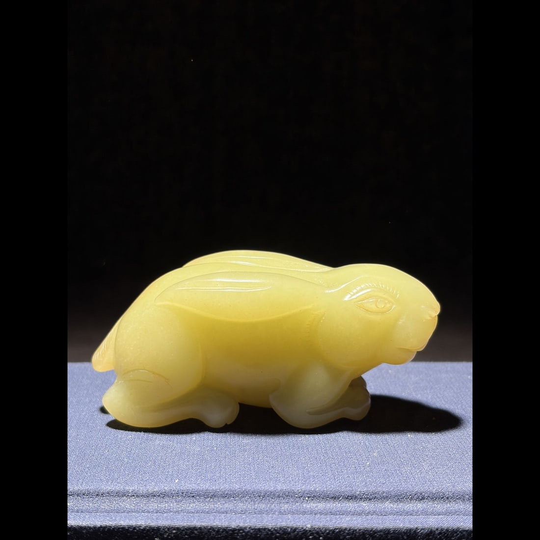 An Exquisite Hotan Yellow Jade Rabbit Ornament: An Exquisite Hotan Yellow Jade Rabbit Ornament,Qing Dynasty, China,Size:3.5inx1.5inx1.3in,Weight:188.5g 和田黄玉兔摆件,中国清代