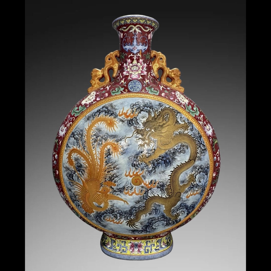 An Exquisite Ruby Red-Ground Enamel Painted Gold Dragon and Phoenix Pattern Vase: An Exquisite Ruby Red-Ground Enamel Painted Gold Dragon and Phoenix Pattern Vase,Qing Dynasty, China,Qianlong Six‑character Mark,Size:22.2inx4.2inx17.3in 胭脂红地珐