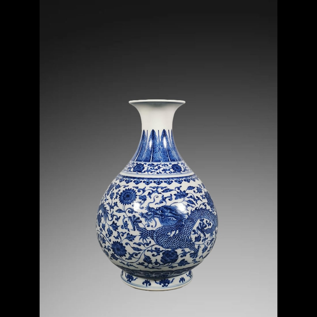 An Exquisite Blue and White Lotus Dragon Pattern Vase: An Exquisite Blue and White Lotus Dragon Pattern Vase,Qing Dynasty, China,Qianlong Six-character Mark,Size:12inx3.7inx7.9in 青花缠枝莲纹龙纹瓶,