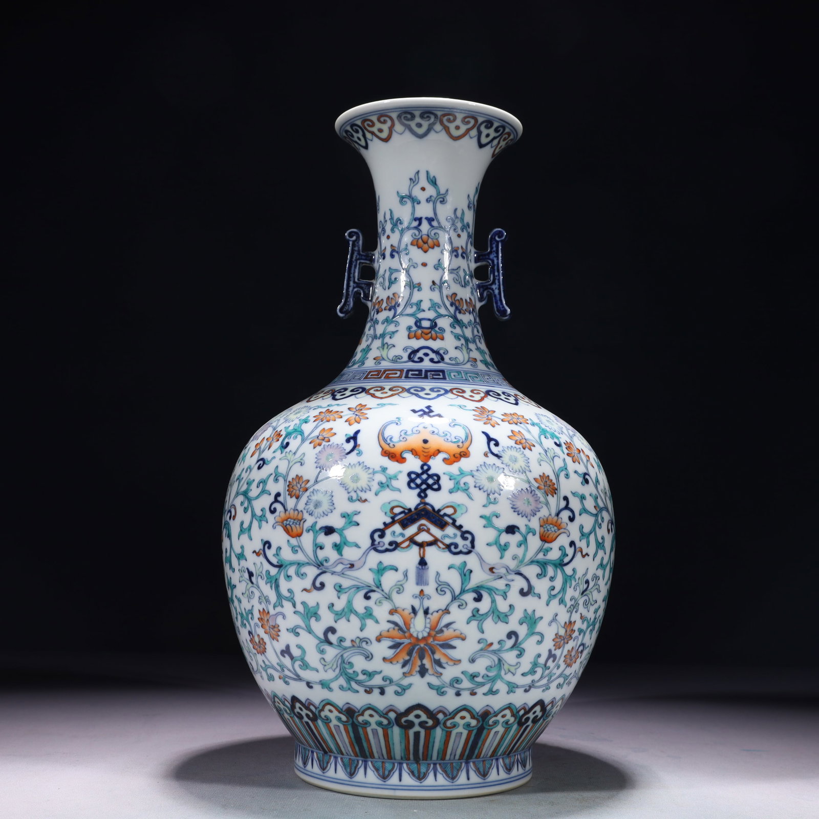 An Exquisite Blue and White Doucai Lotus Pattern Double-Ears Vase: An Exquisite Blue and White Doucai Lotus Pattern Double-Ears Vase,Qing Dynasty,China,Qianlong Six-character Mark,Size:7.9inx14.6in,Weight:2200g 青花斗彩缠枝莲