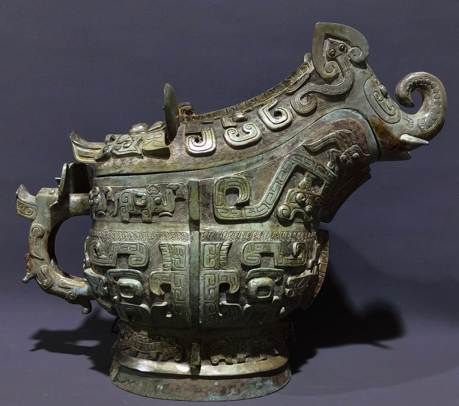 A Huge Bronze Beast-Face Pattern Elephant-Shaped Cup: A Huge Bronze Beast-Face Pattern Elephant-Shaped Cup,Shang and Zhou Dynasty, China,Size:12.8inx16.1inx8.7in,Weight:7.5kg 中国商周时期兽面纹青