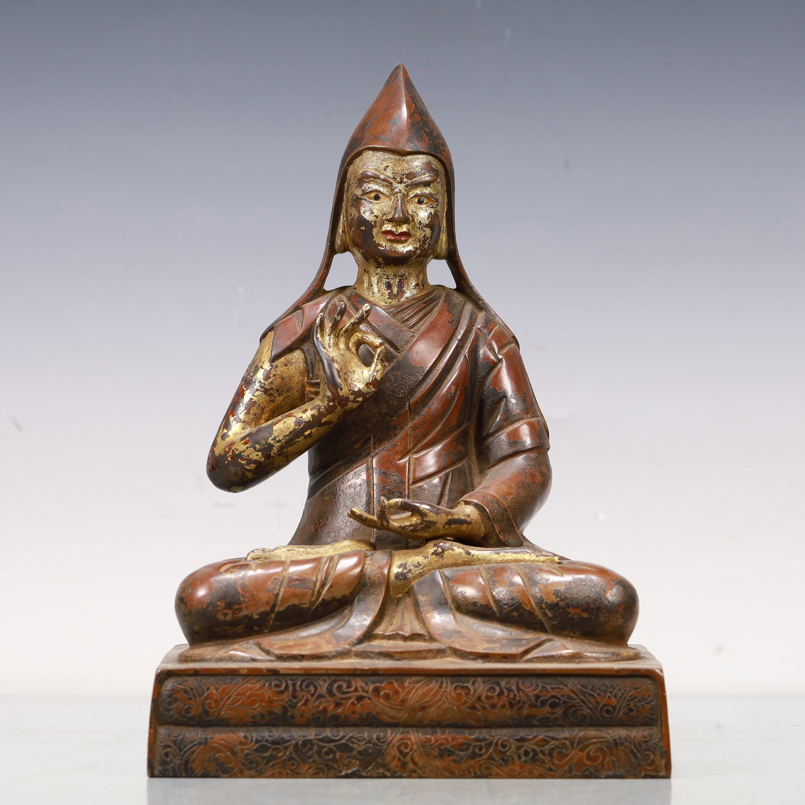 An Excellent Gilt-Bronze Figure Of Tsongkapa: An Excellent Gilt-Bronze Figure Of Tsongkapa. The figure with a dignified expression is rendered clad in long,flowing robes,the voluminous drapery elegantly cascading in folds,topknot surmounted by a 