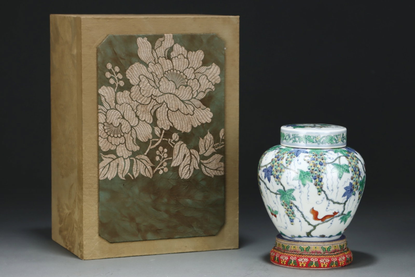 An Exquisite Doucai Squirrel and Grapes Pattern Jar with Cover: An Exquisite Doucai Squirrel and Grapes Pattern Jar with Cover,Ming Dynasty,China,Chenghua Six-character Mark,Size:5.4inx5.1in 斗彩松鼠葡萄纹盖罐,
