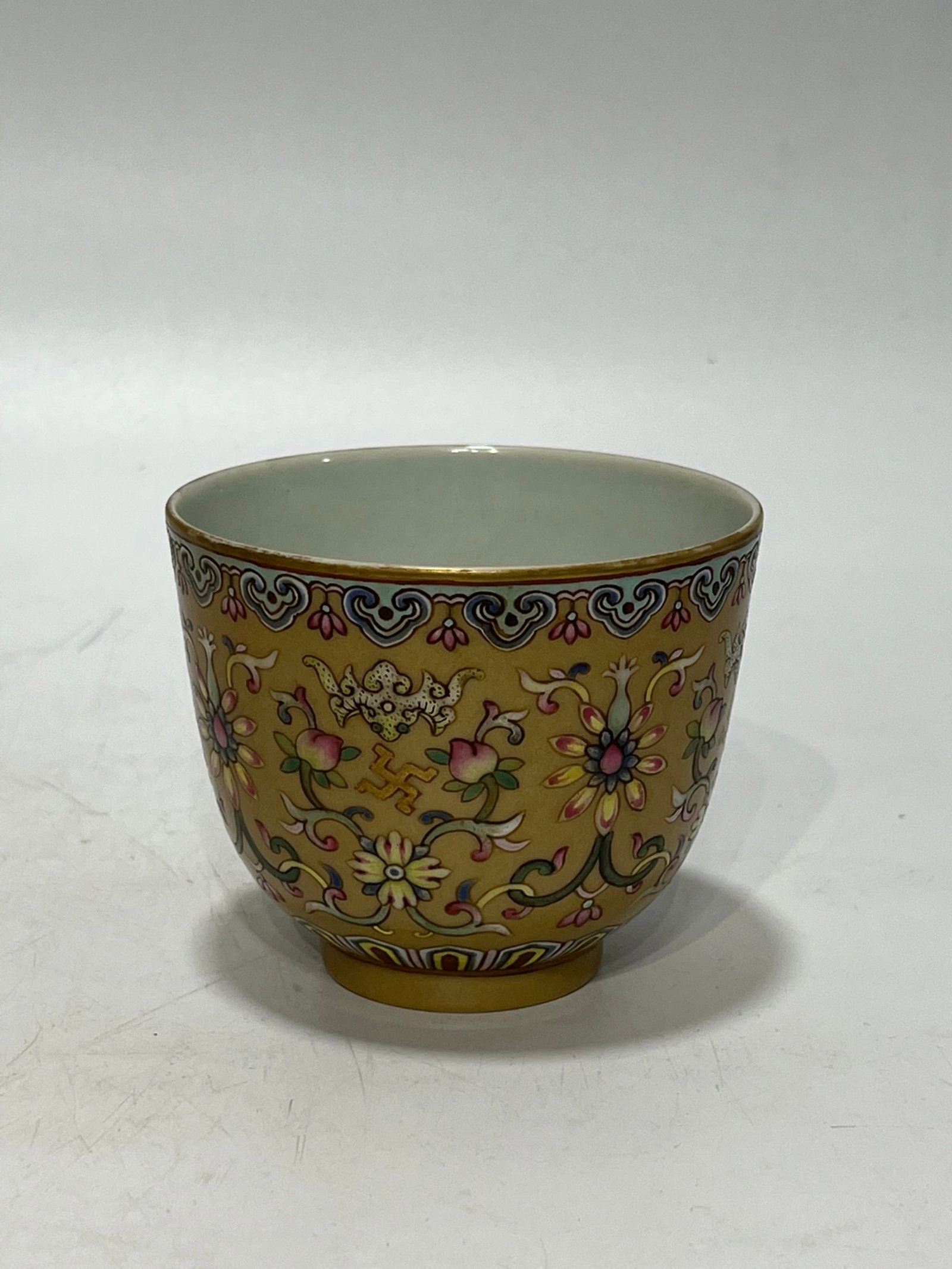 An Exquisite Famille-Rose Yellow Ground Painted Gold Bats and Peach Pattern Cup: An Exquisite Famille-Rose Yellow Ground Painted Gold Bats and Peach Pattern Cup,Qing Dynasty,China,Daoguang Six-character Mark,Size:3.1in 粉彩黄地描金福ळ