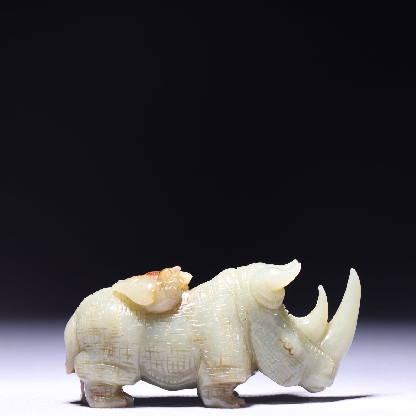 An Exquisite Green Jade Rhinoceros Ornament: An Exquisite Green Jade Rhinoceros Ornament,Qing Dynasty,China,Size:3.9inx1.2inx2in,Weight:213g 青玉犀牛摆件,中国清代